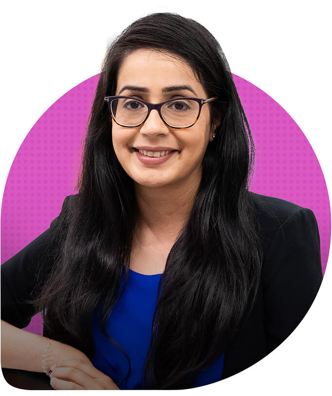 Headshot of Dr. Keerat Grewal in front of a pink circle background