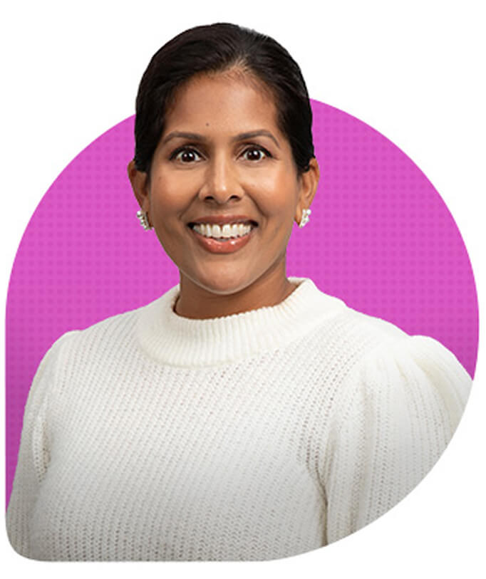 Headshot of a smiling woman wearing a white sweater