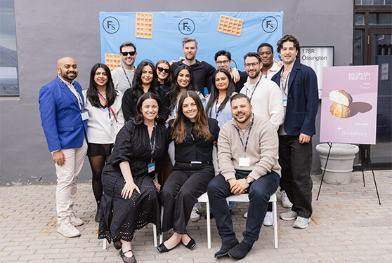 A diverse group of smiling people posing together at an event