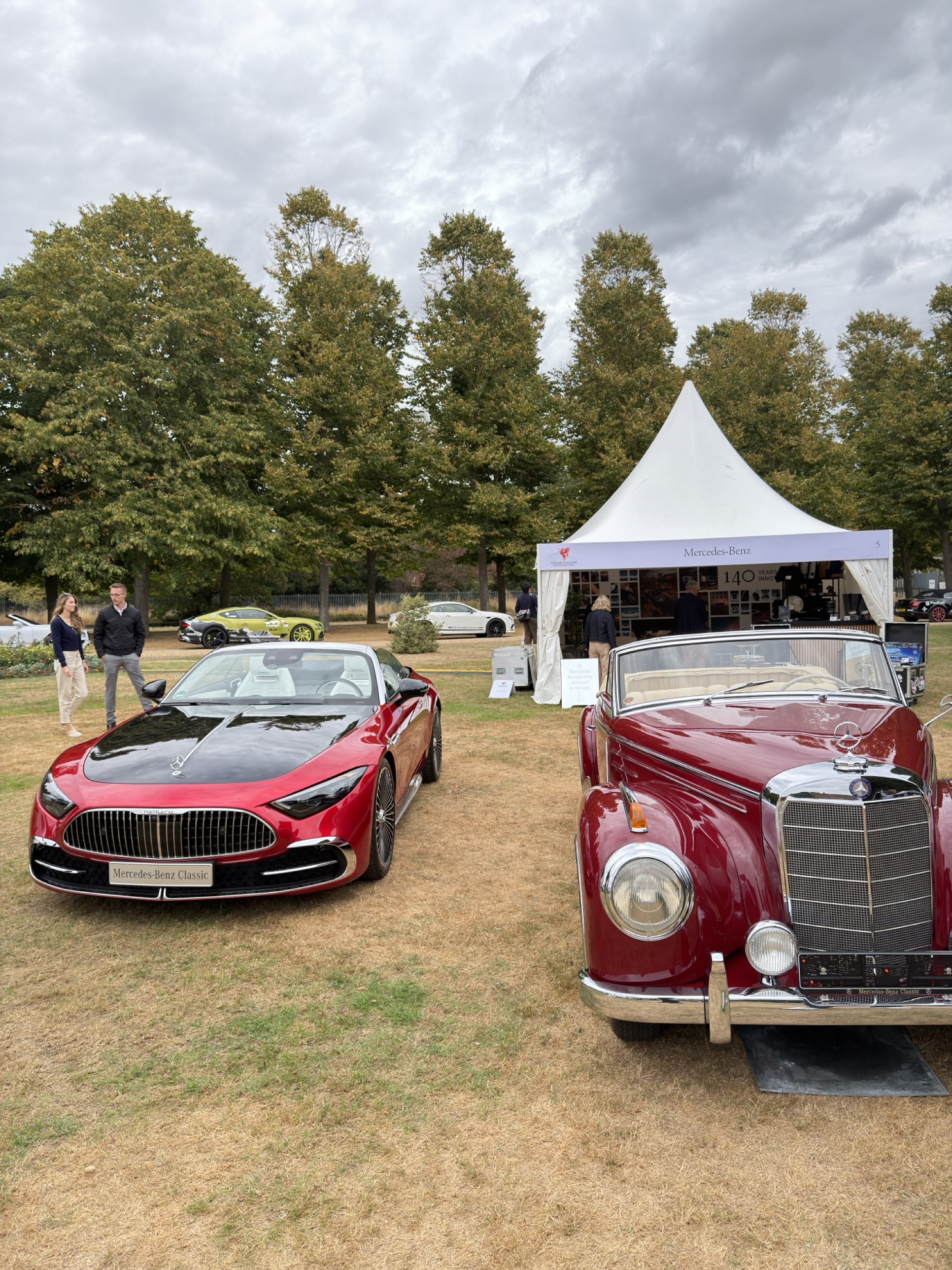 A modern Mercedes-Maybach beside a 1950s Mercedes 300 cabriolet at the Mercedes-Benz Classic stand, Hampton Court.