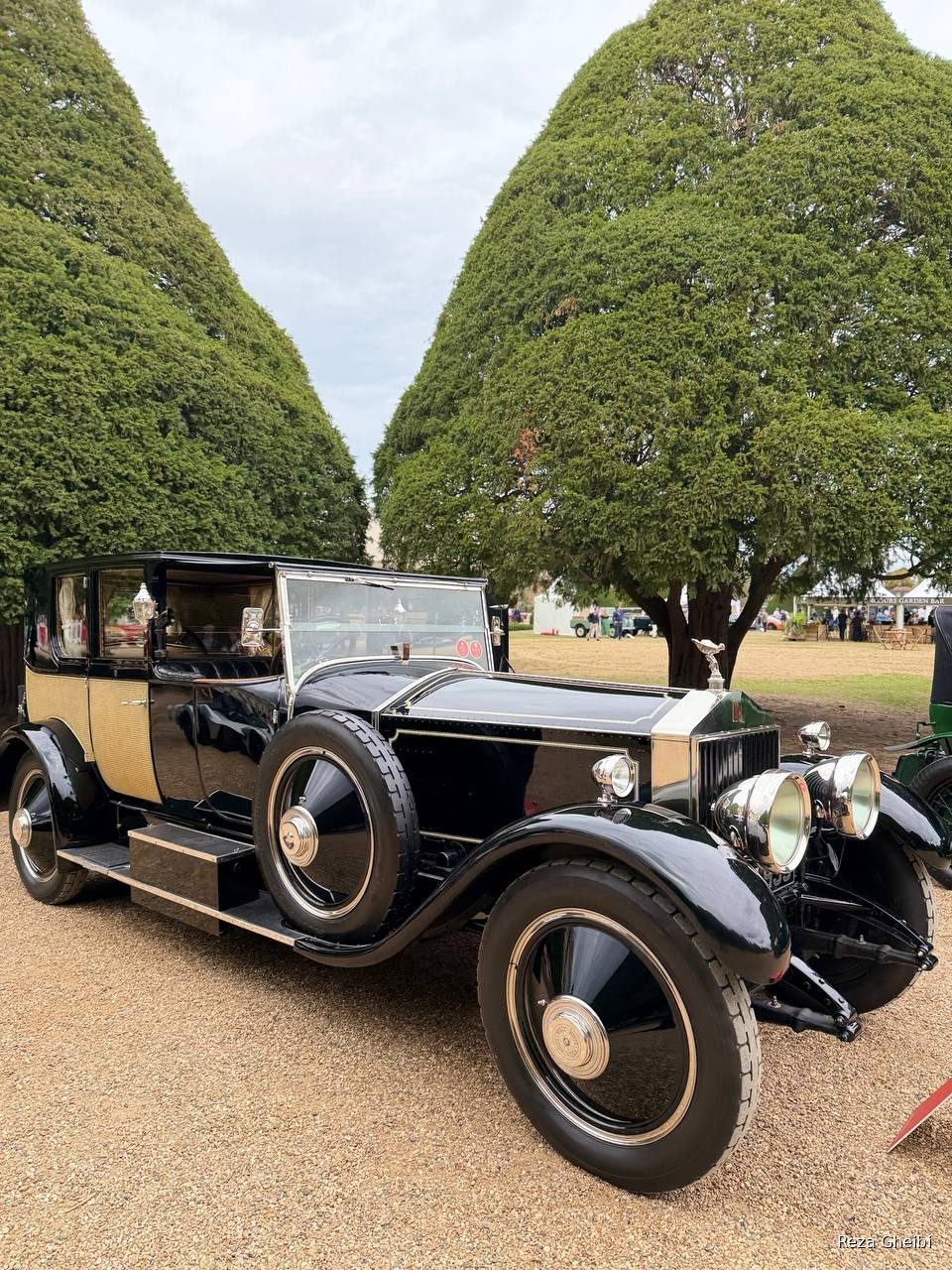 A black 1920s Rolls-Royce Phantom with cane side panelling and brass lamps.