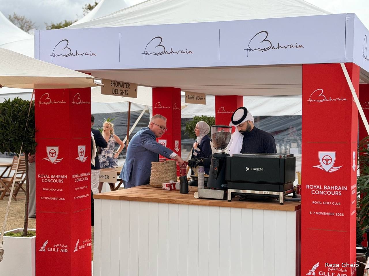 The Royal Bahrain Concours stand pouring coffee, branded for its 6 to 7 November 2026 event at the Royal Golf Club.