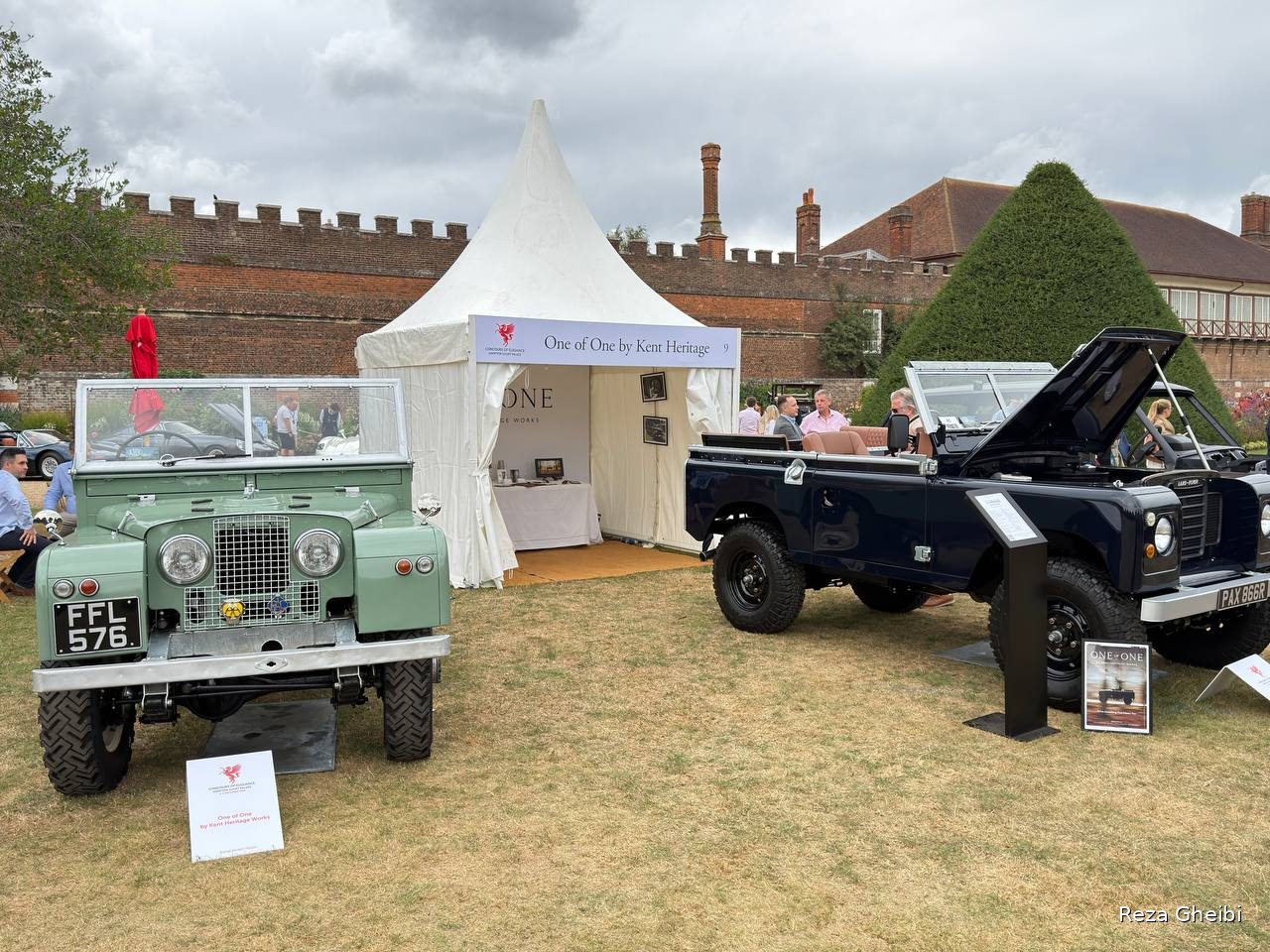 A restored green Land Rover Series I and a dark restomod Land Rover at the One of One by Kent Heritage stand.