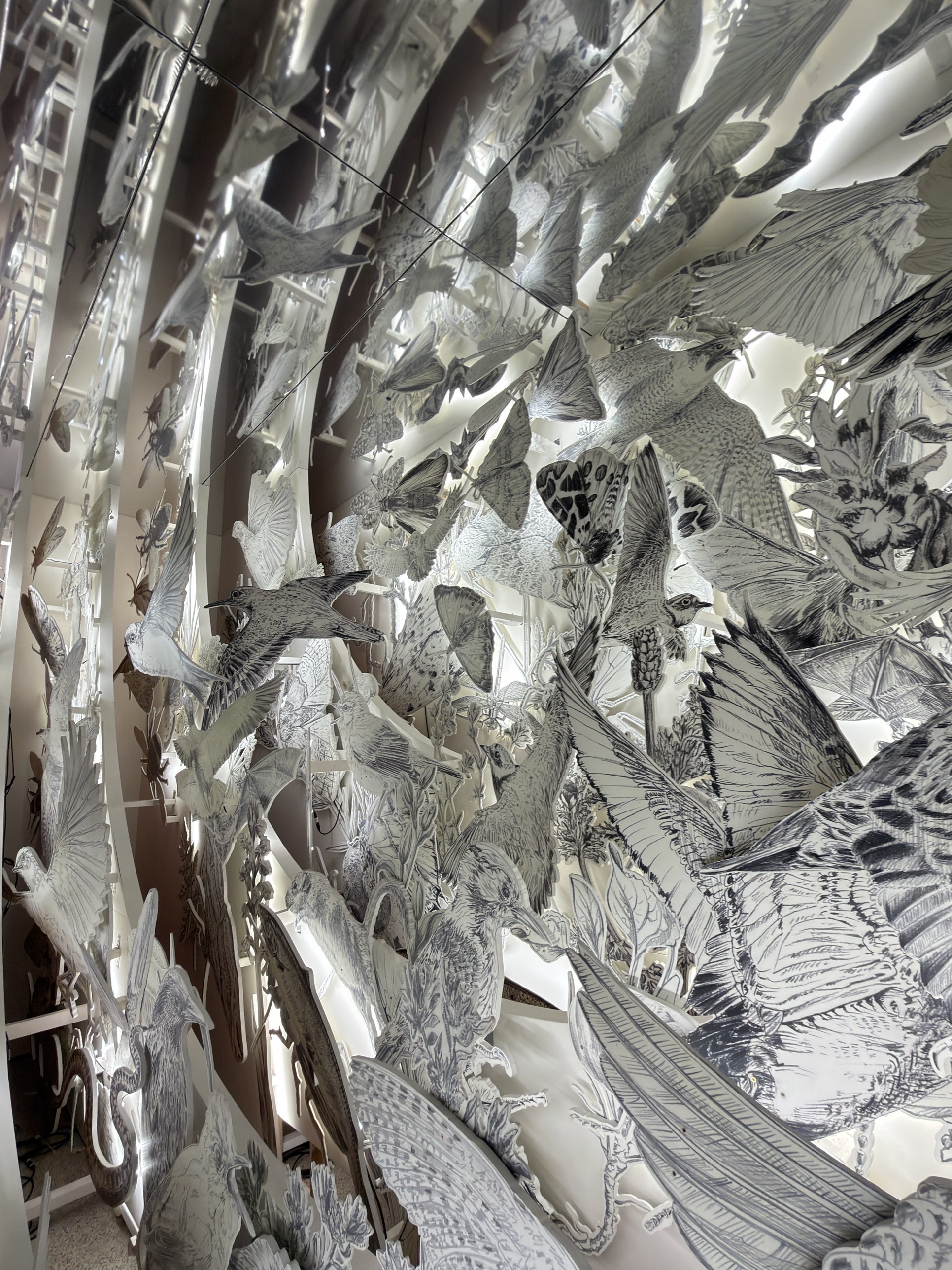 Inside Es Devlin Come Home Again: a domed enclosure densely drawn with birds, insects and plants in black and white.