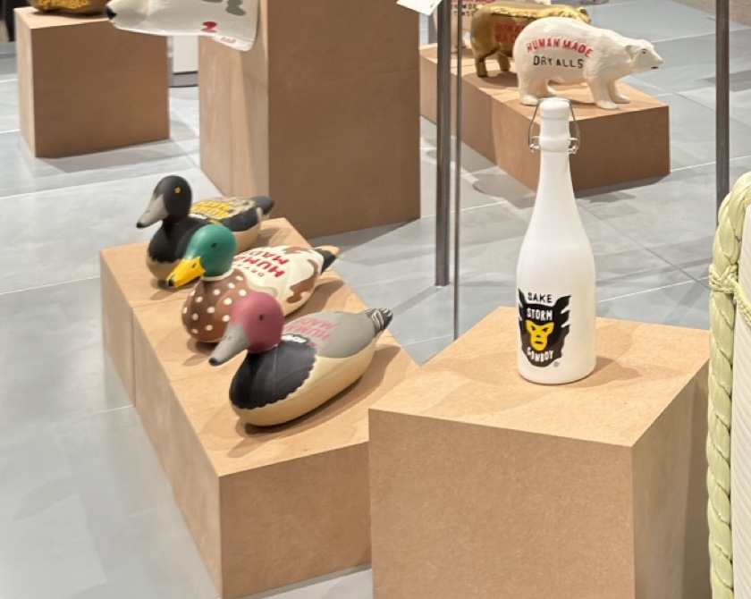 Painted wooden decoy ducks on a plinth in the Human Made room