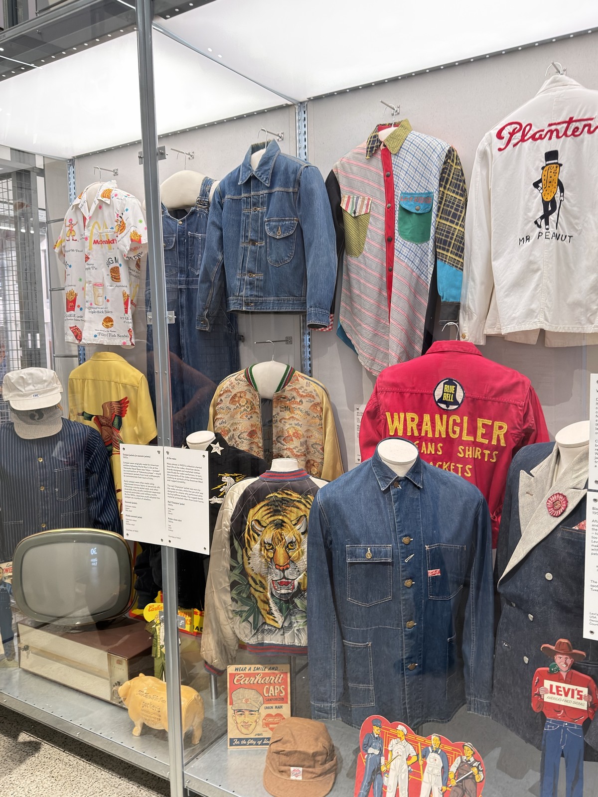 A vitrine wall of sukajan souvenir jackets, denim, workwear and a Mr Peanut shirt