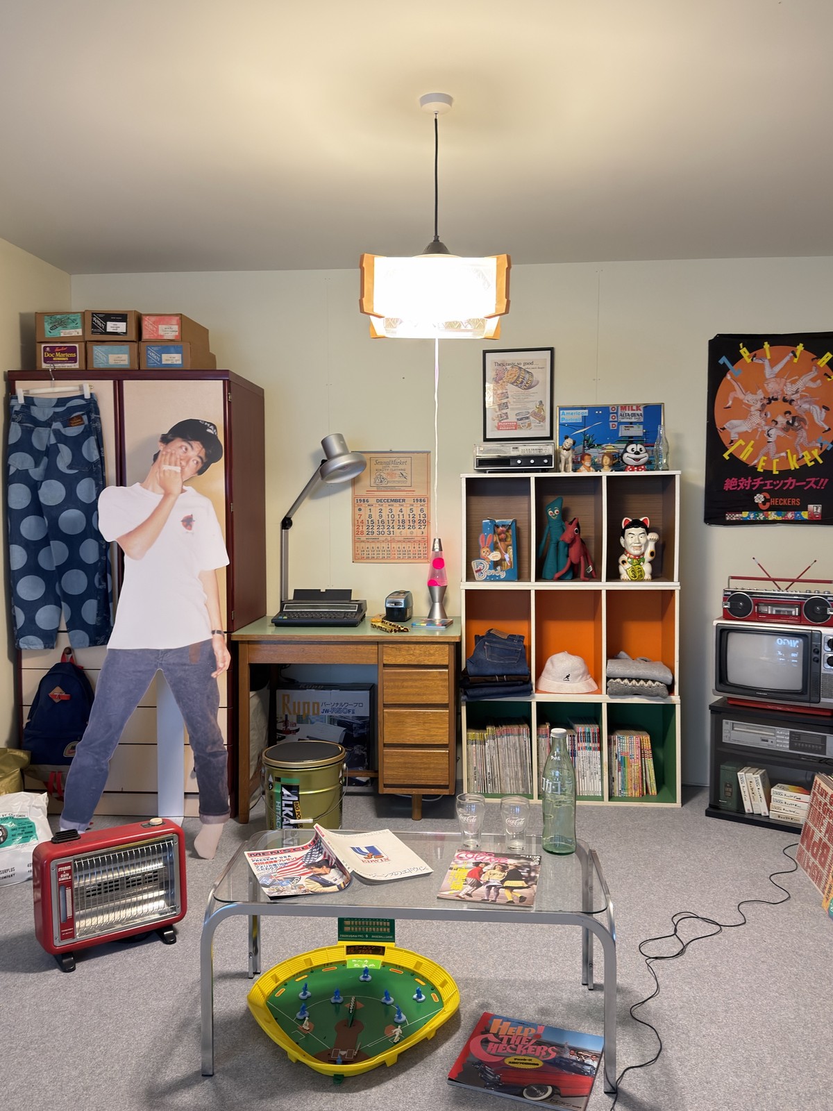 A recreated 1980s Japanese teenage bedroom with magazines, denim, toys and a life-size cut-out of NIGO