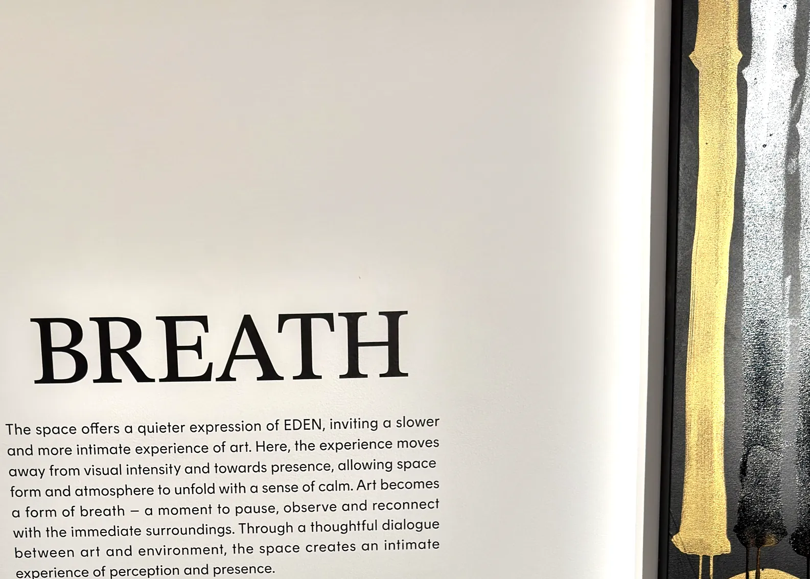 A gallery wall headed BREATH carrying a curatorial paragraph about a quieter, slower experience of art
