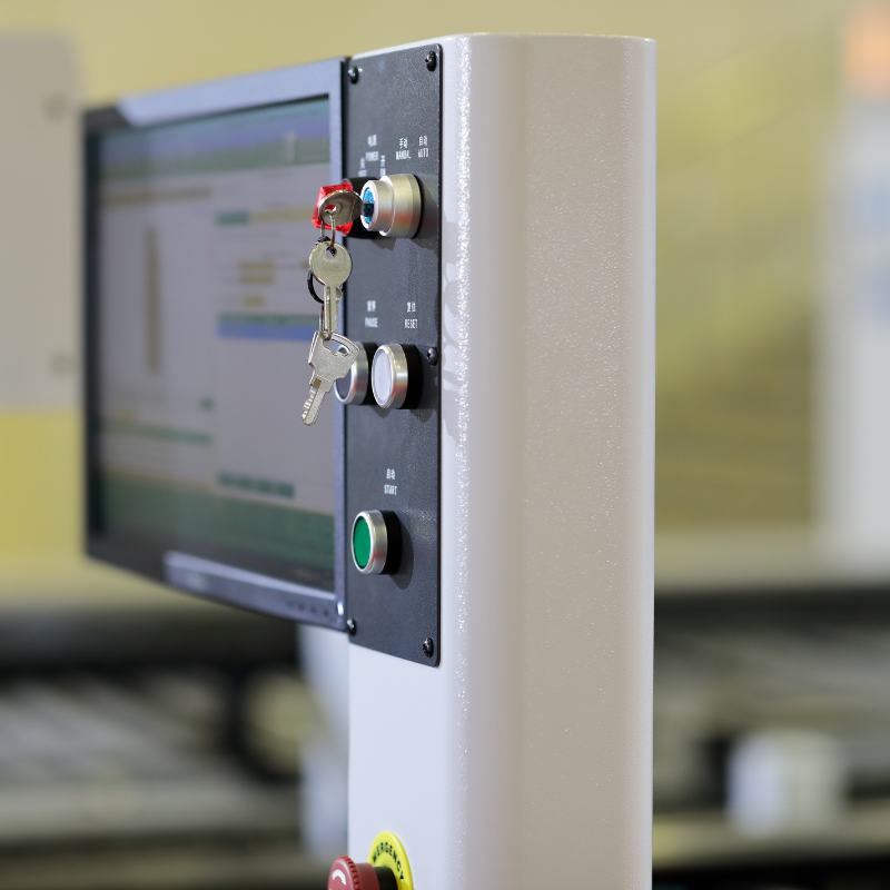 Control panel with a screen, key switch, buttons, and two keys inserted in the switch.