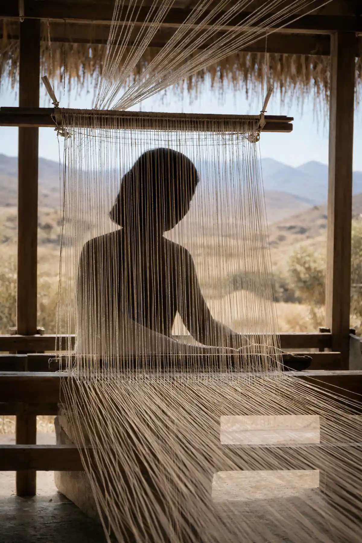 Berber weaver at a traditional loom, Middle Atlas, Morocco
