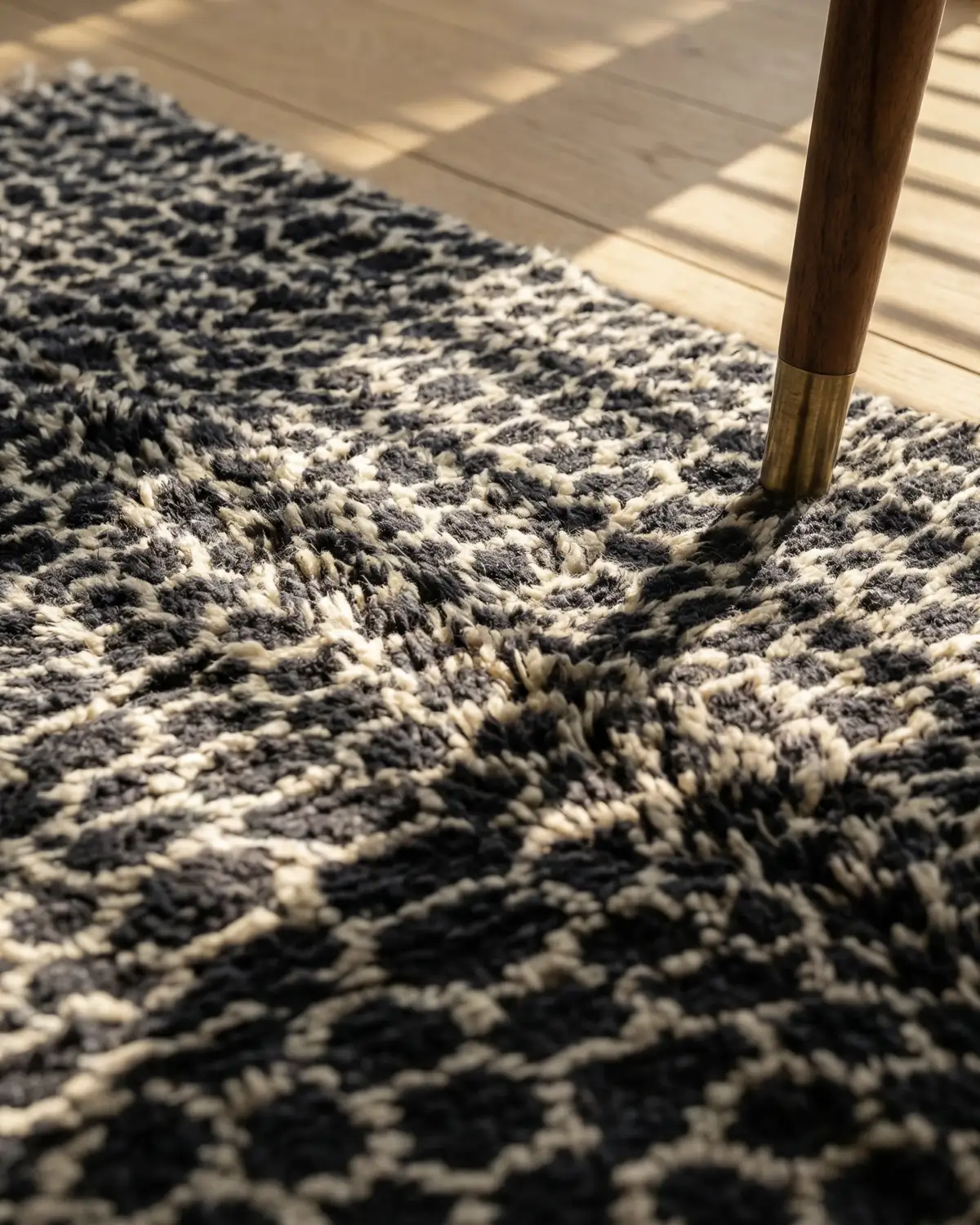 Lior Moroccan rug – close-up of dense black and white animal-pattern wool texture on oak floor