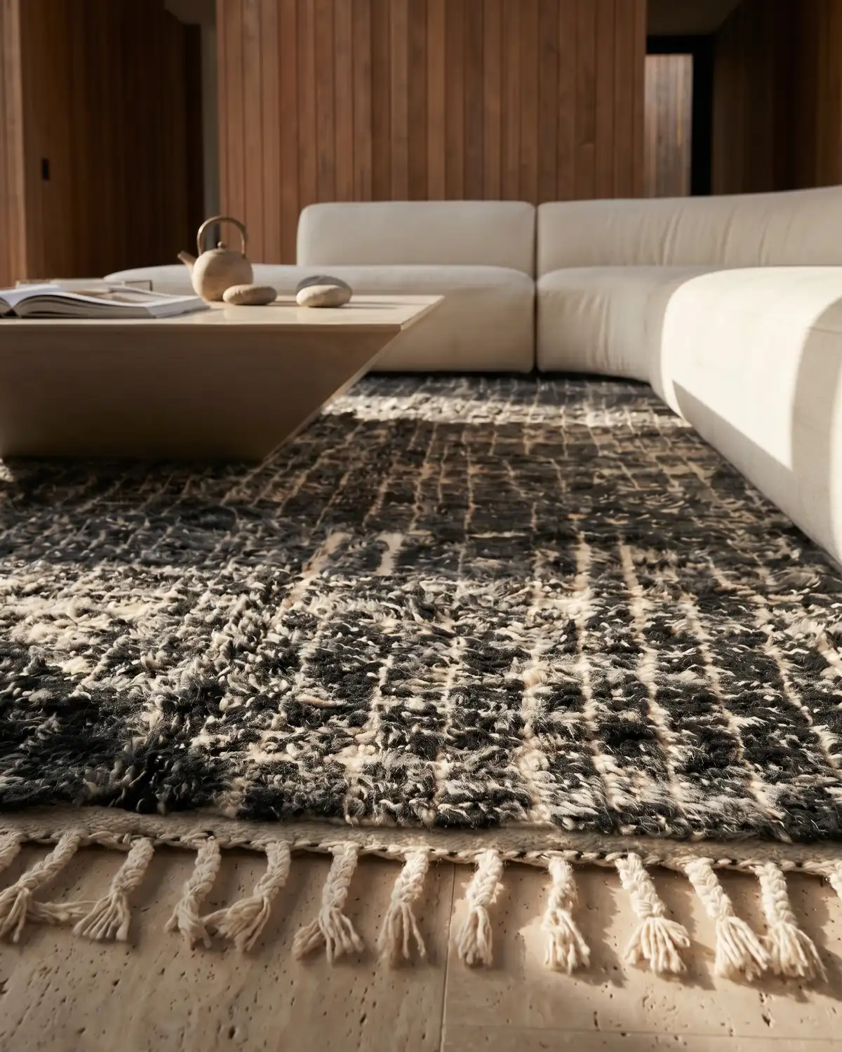 Hector black Moroccan rug – low-angle detail of dense wool surface and ivory knotted fringe against a warm timber interior