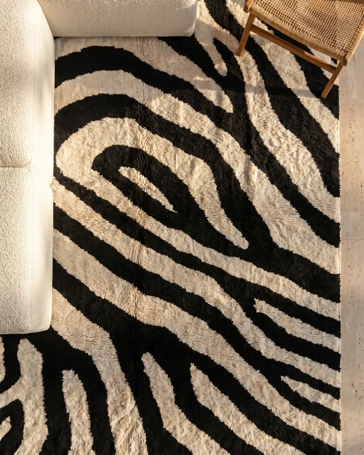 Jade zebra-pattern Moroccan rug – overhead view styled with a white sofa and rattan chair