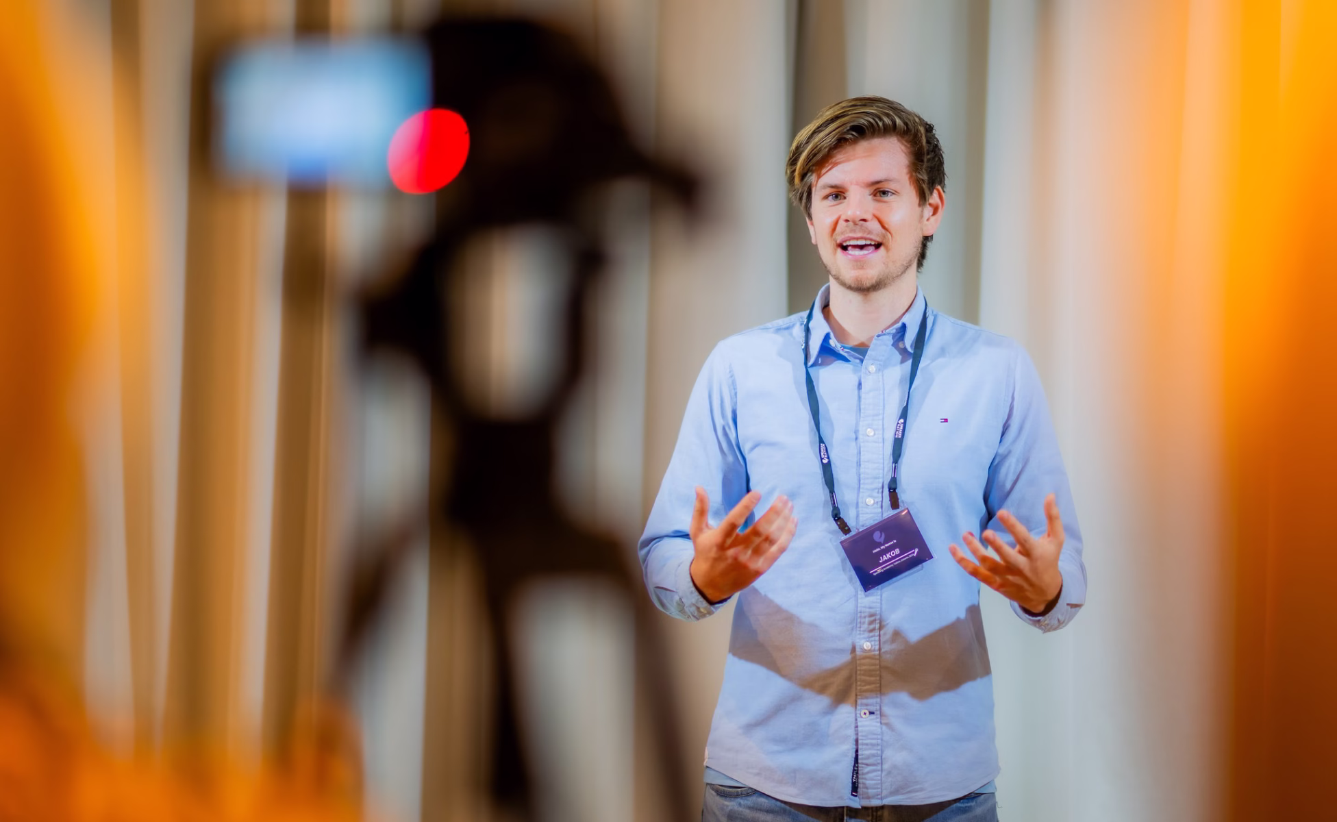 Jakob speaking in front of a camera