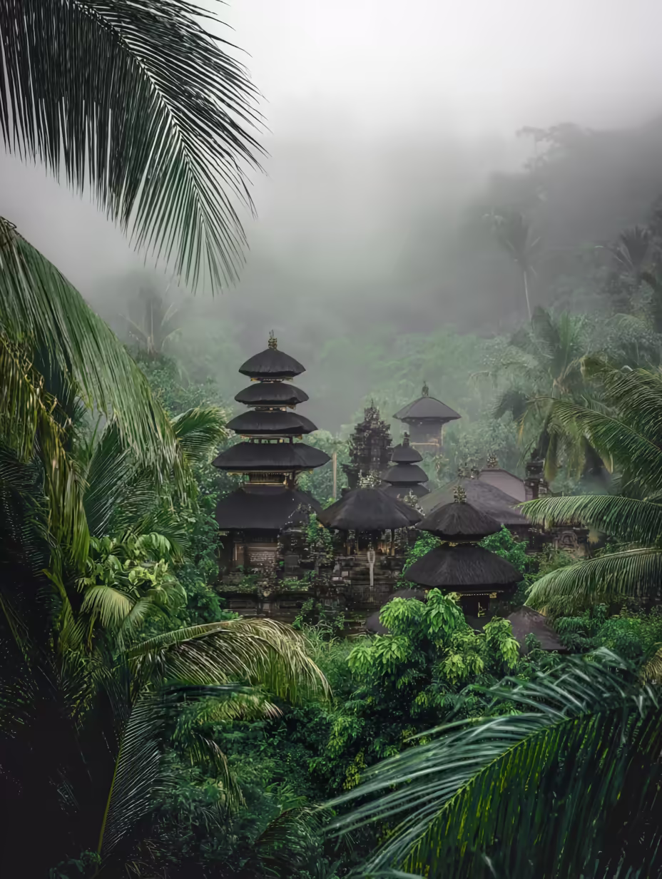 A traditional multi-tiered Balinese temple nestled among dense, misty green jungle foliage under a hazy sky.