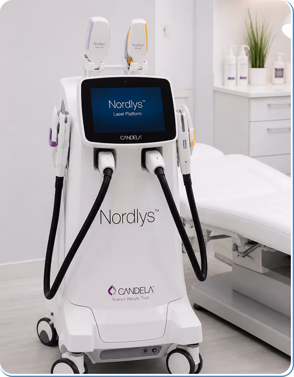 Nordlys laser platform machine by Candela in a clinical room with treatment bed and skincare bottles.