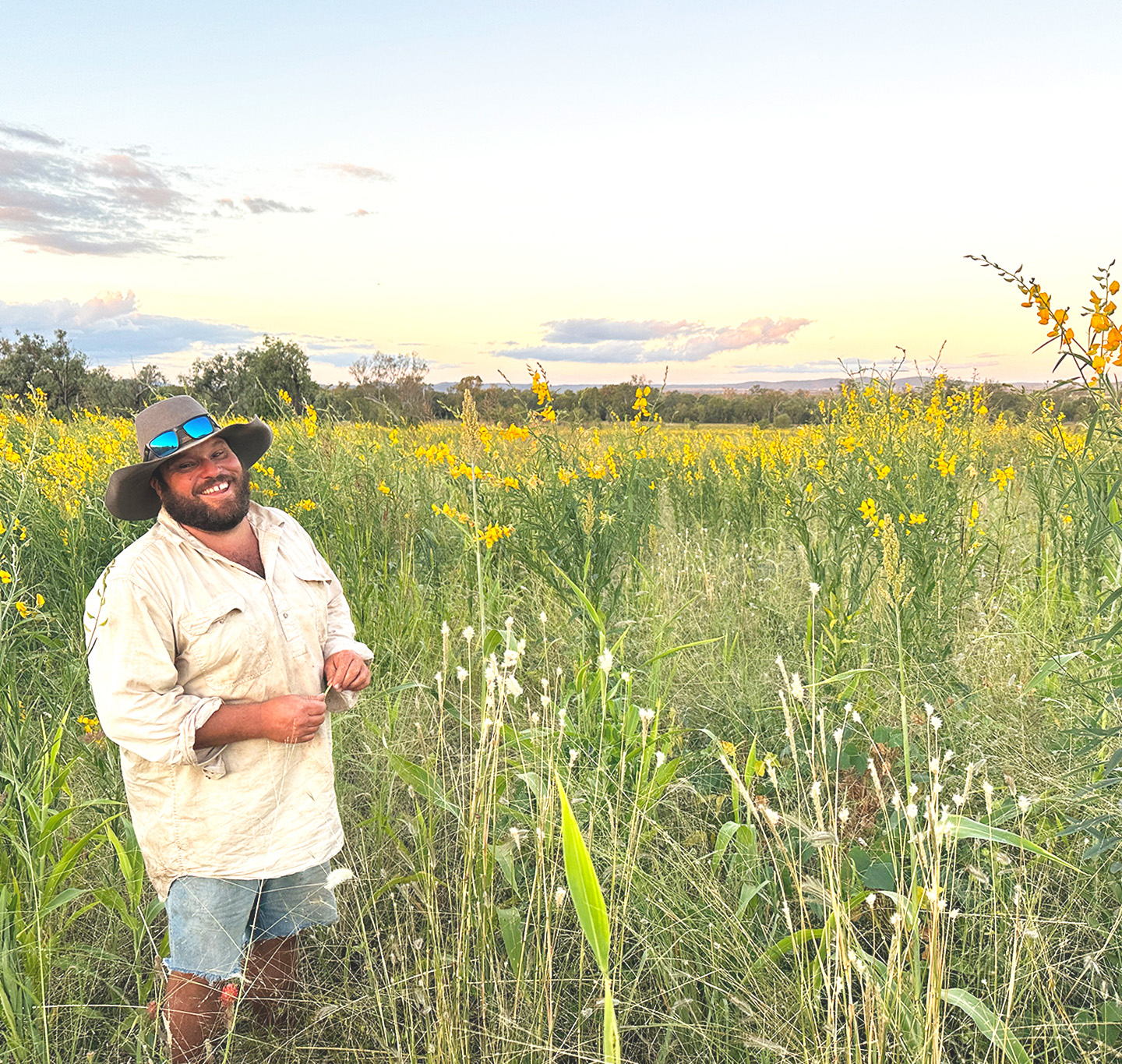 The farm manager stands in a field