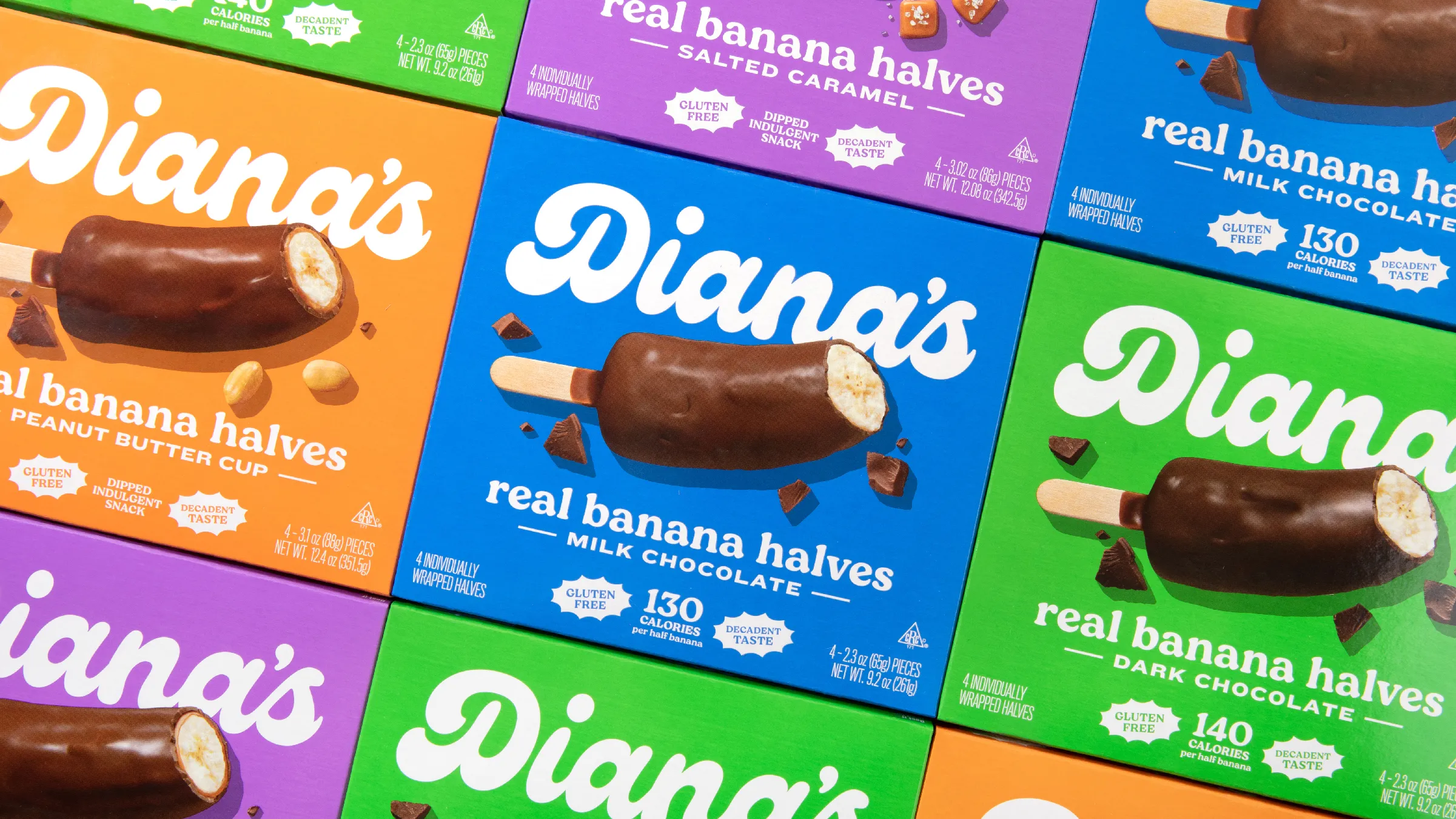 Diana's chocolate-dipped frozen banana boxes in orange, blue, purple, and green flavor variants.