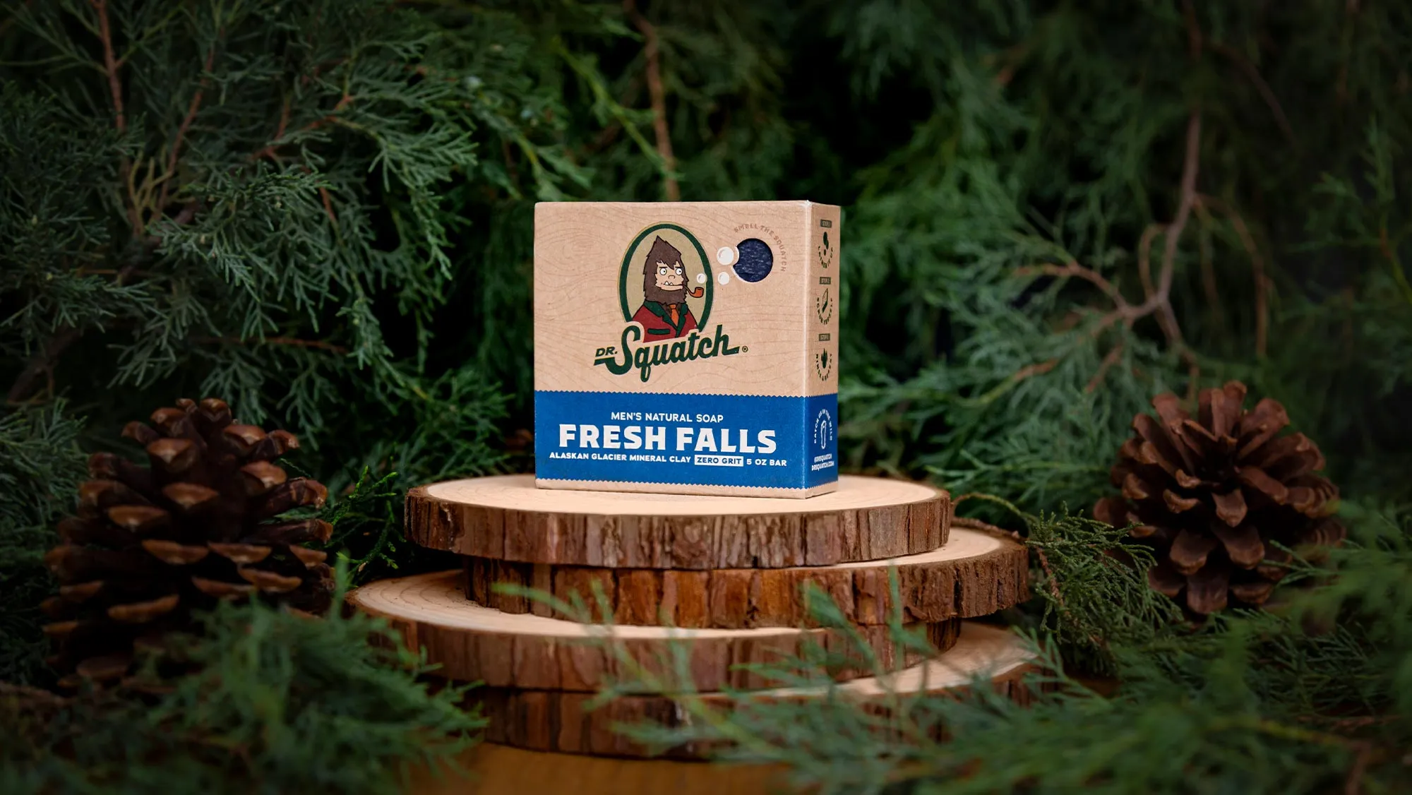 Fresh Falls Dr. Squatch soap box with Alaskan Glacier Mineral Clay on stacked wood slices.
