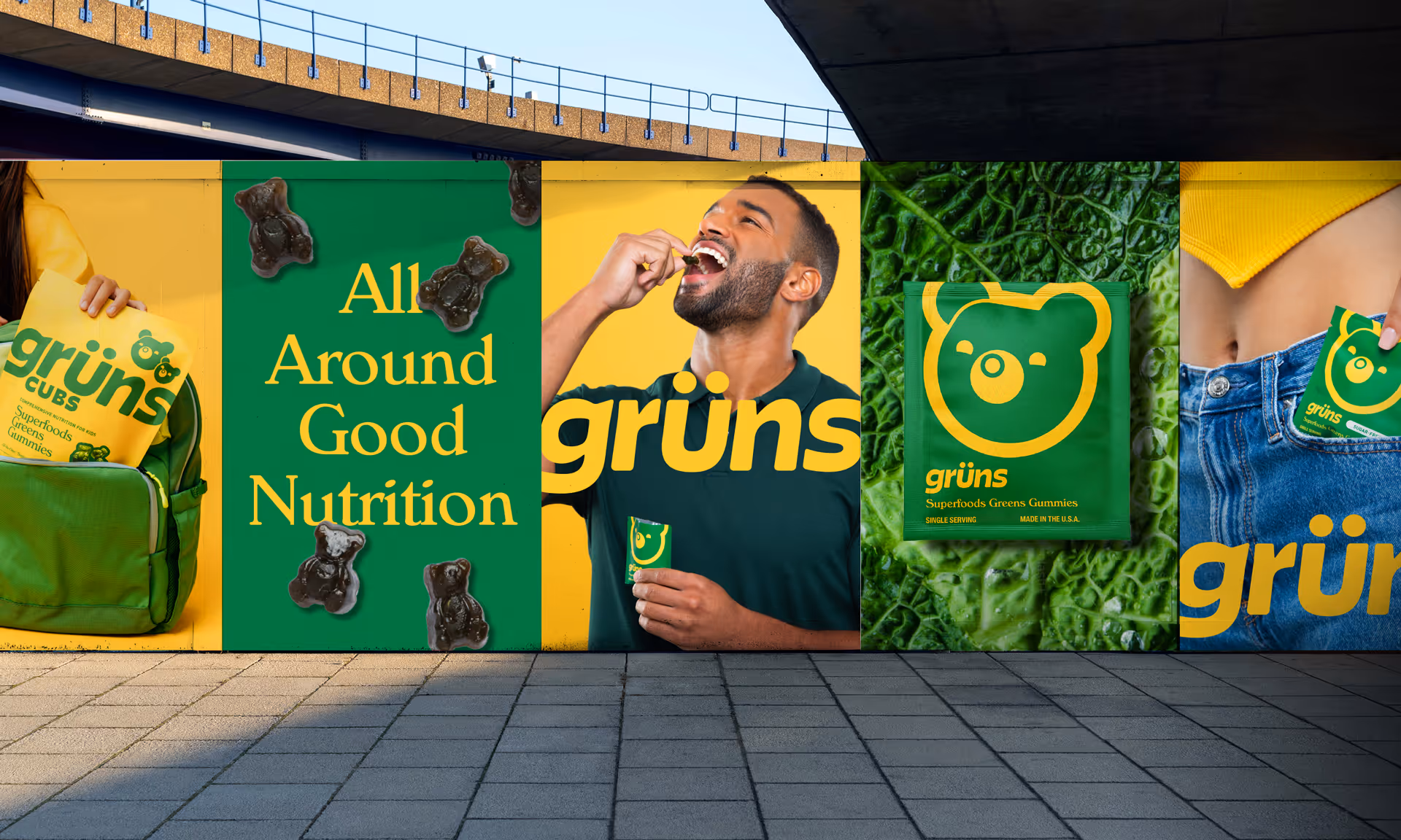 Wheatpasted Grüns posters under a bridge featuring the Cubs pouch, a single-serve sachet, and the bear mascot.