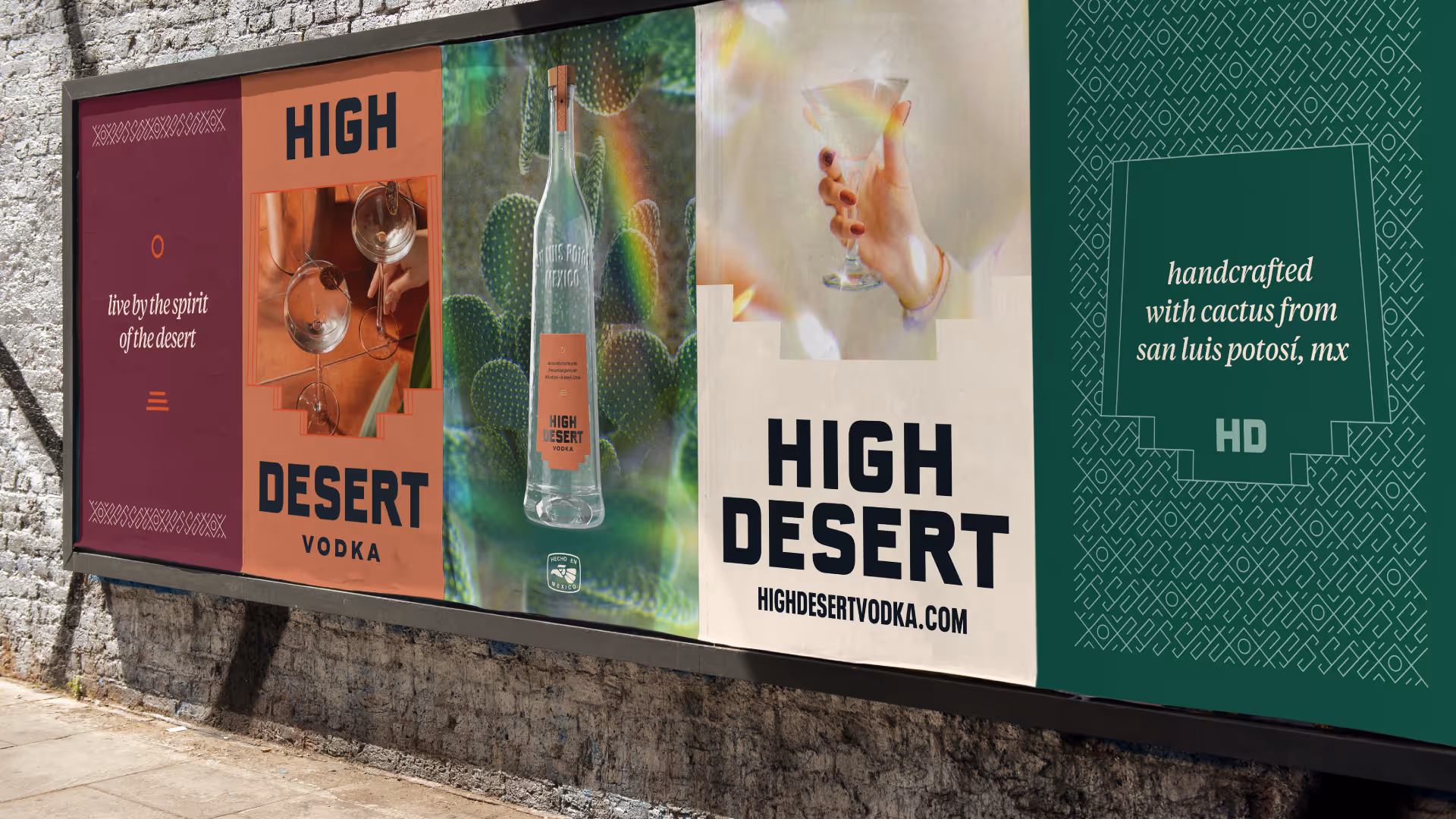 Wheatpasted wall of five High Desert posters: 'Live by the spirit of the desert,' wordmark, bottle, and cactus art.