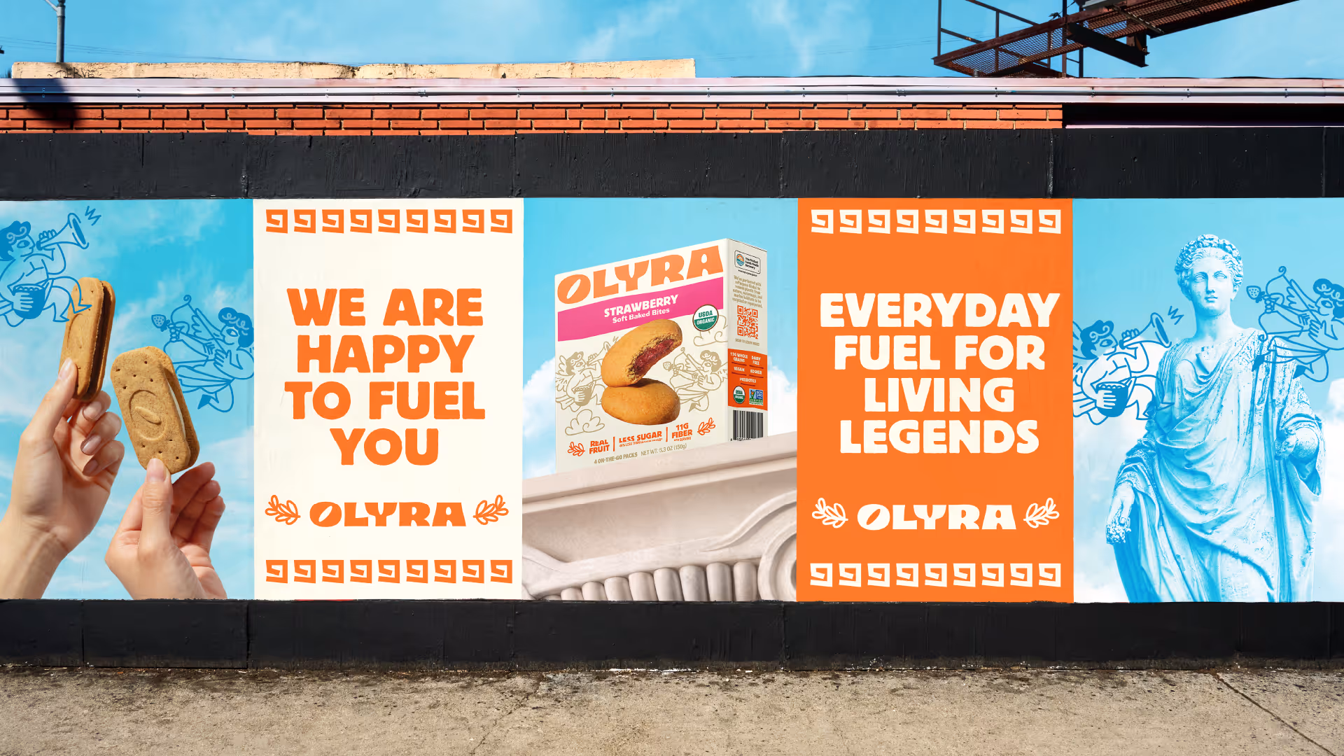 Olyra billboard wall: hand with biscuit, Strawberry packaging, and 'Everyday fuel for living legends' beside a Greek statue.