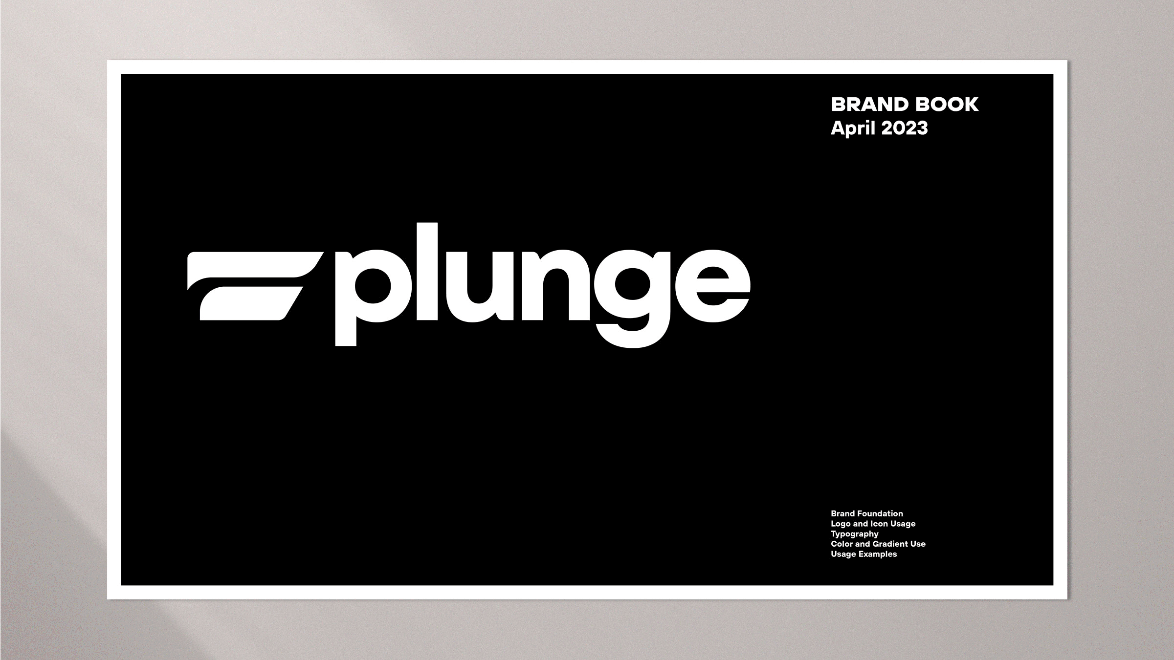 Black Plunge brand book cover on a gray wall showing the white wordmark, dated April 2023, with table of contents.