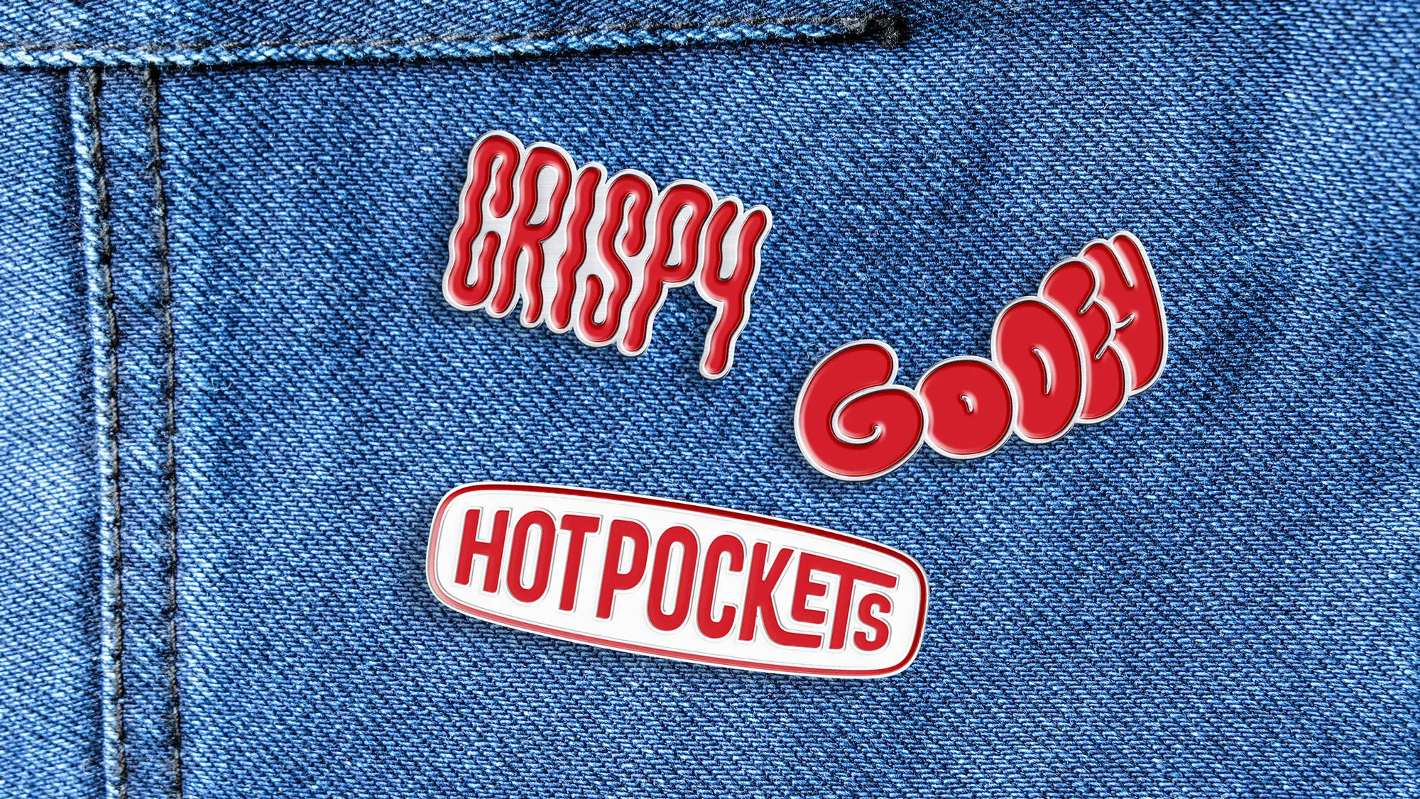 Three Hot Pockets enamel pins on a denim shirt pocket: bubble-letter 'Crispy,' 'Gooey,' and the Hot Pockets logo bar.