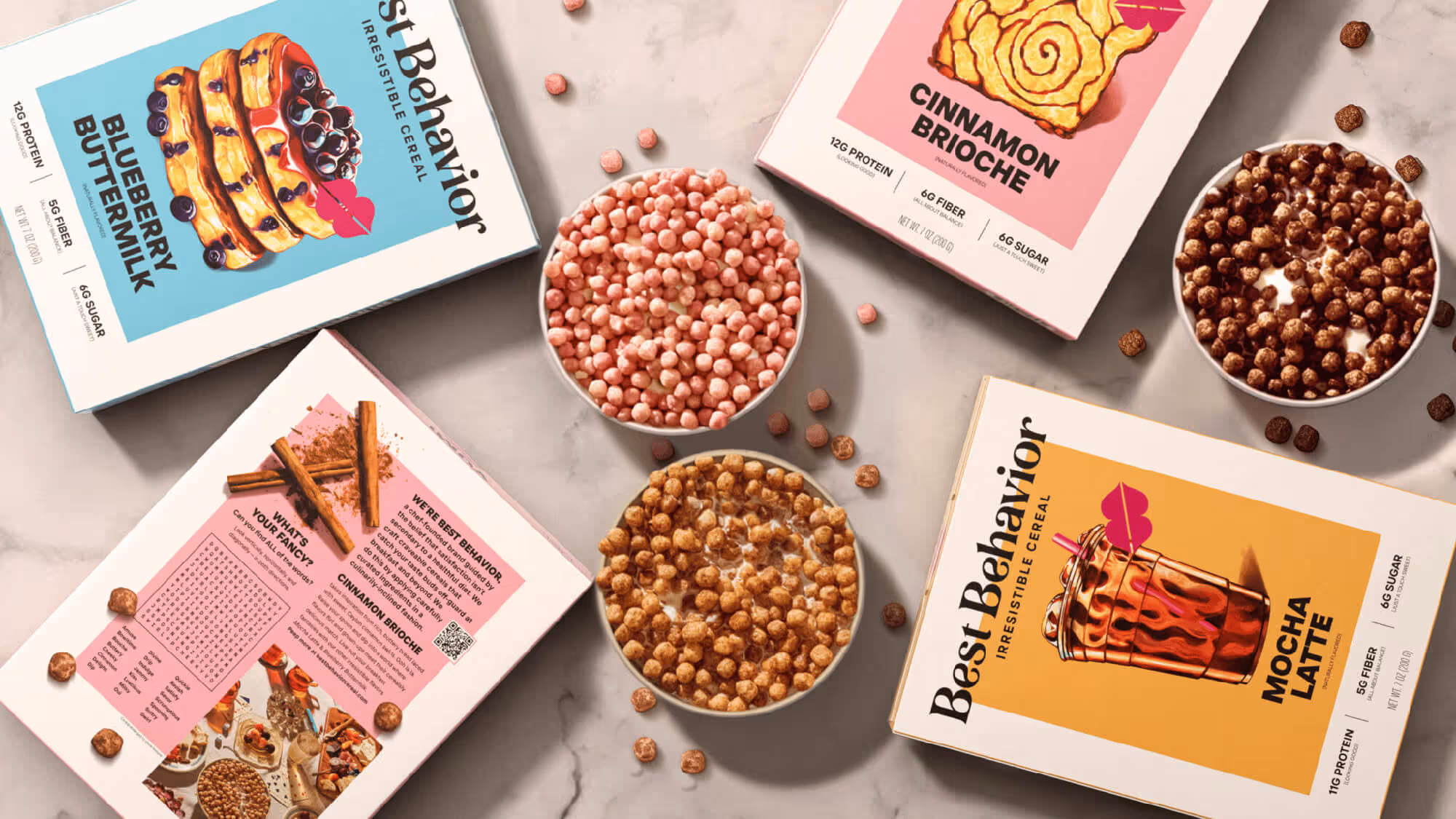 Flat lay of three Best Behavior cereal boxes alongside bowls of cereal puffs, photographed from above.