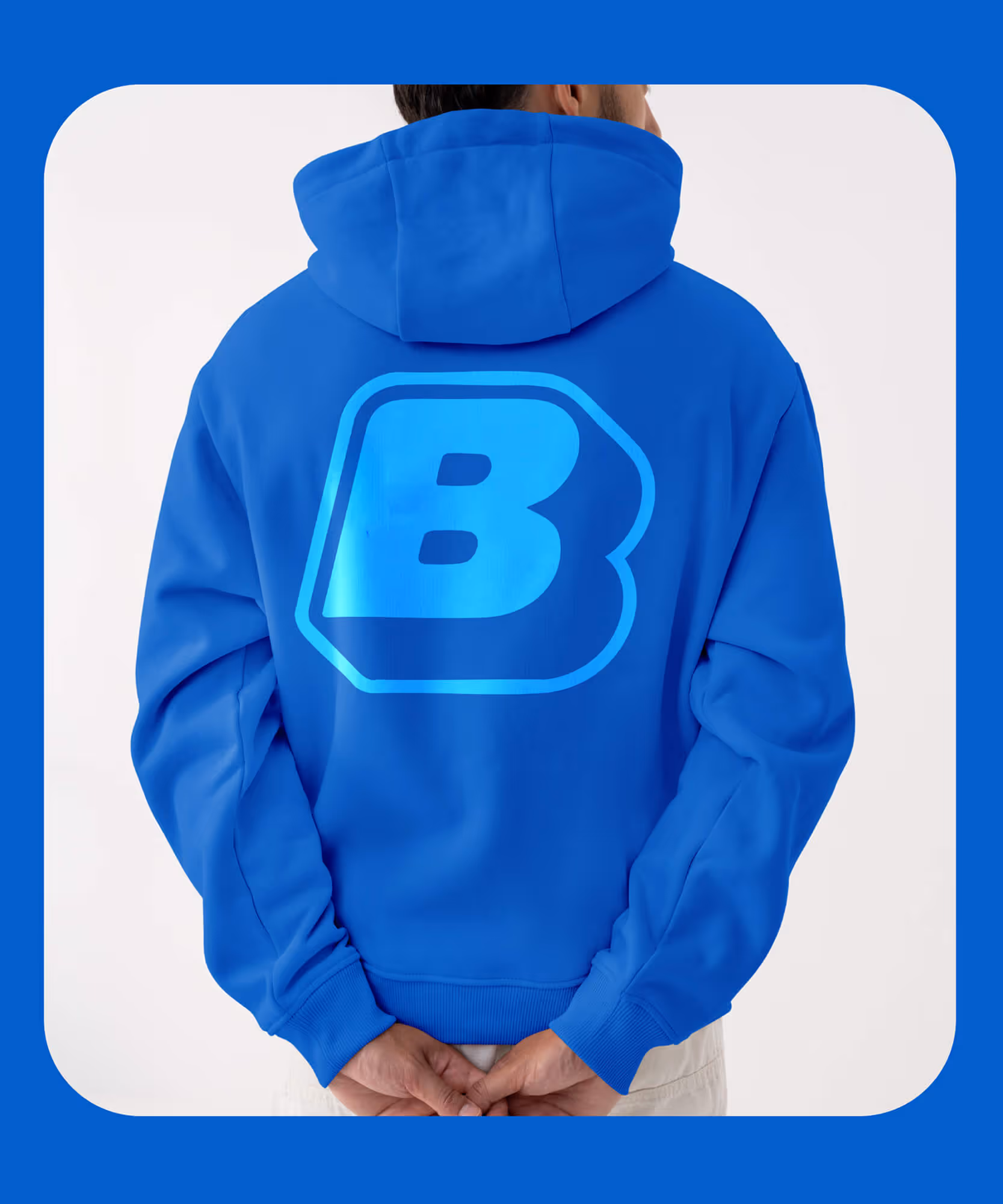 Person in a blue hoodie with a large light-blue puffy 'B' logo printed across the back.