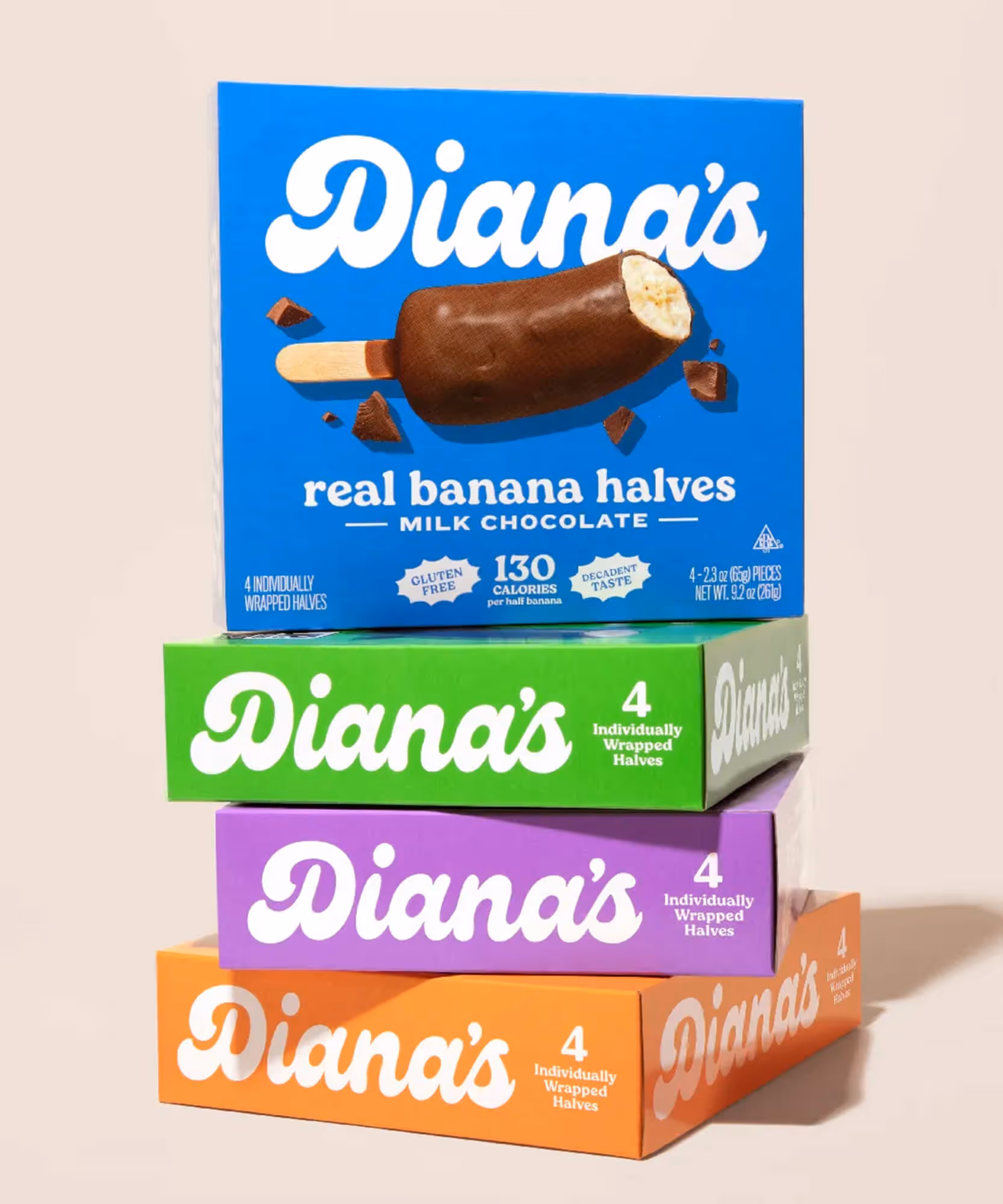 Stack of four Diana's boxes (blue Milk Chocolate on top) on a beige surface.