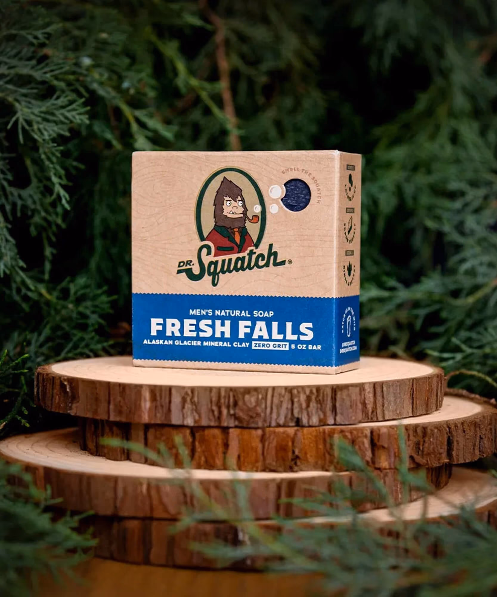 Fresh Falls Dr. Squatch soap box with Alaskan Glacier Mineral Clay on stacked wood slices.
