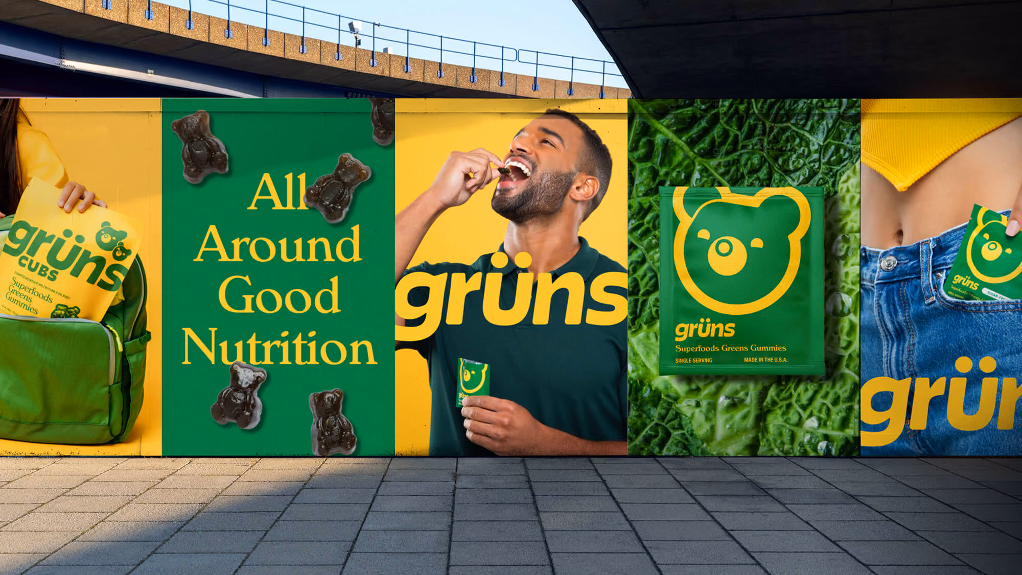 Wheatpasted Grüns posters under a bridge featuring the Cubs pouch, a single-serve sachet, and the bear mascot.