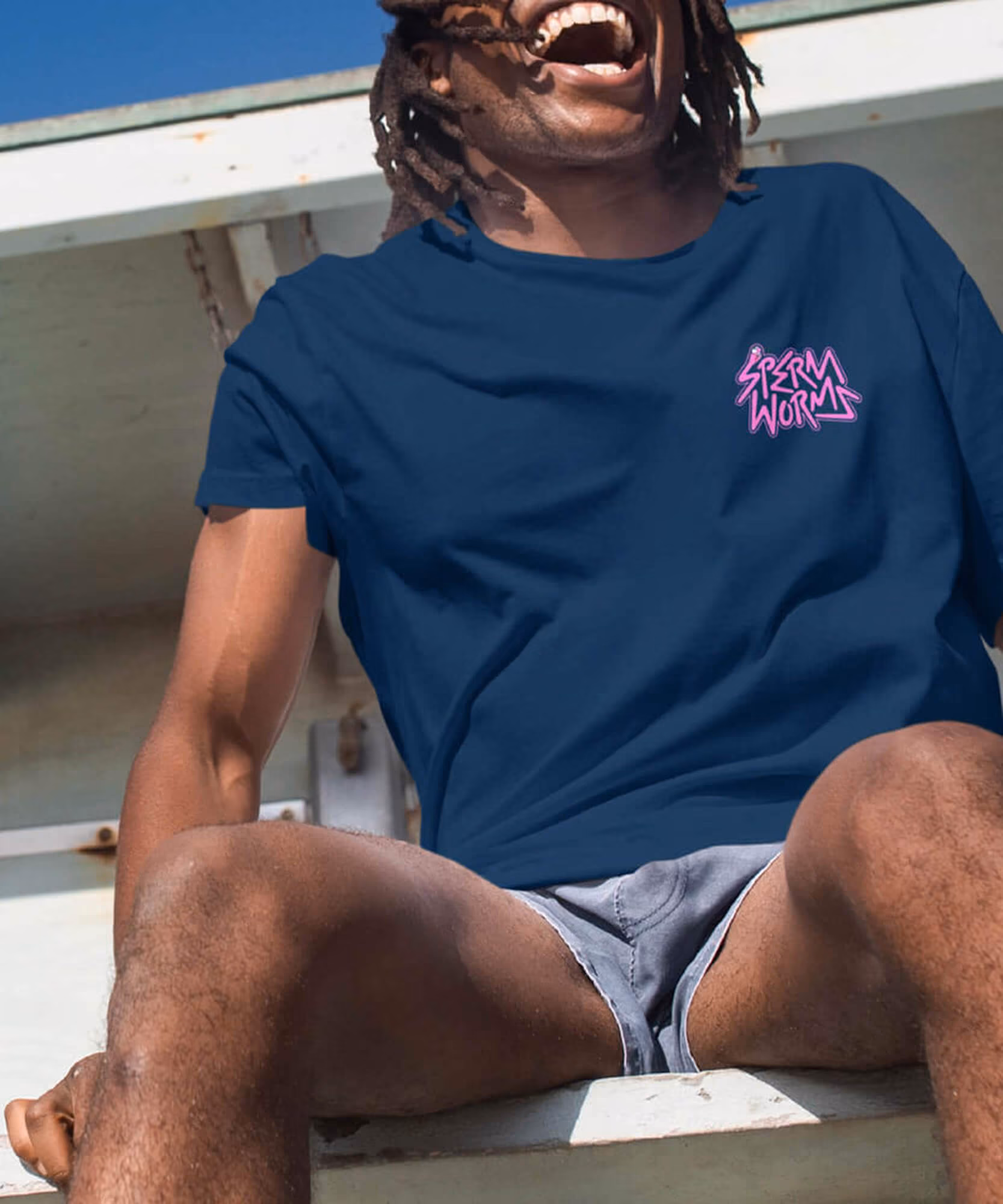 Sperm Worms apparel: yellow worm-printed socks above blue Nike sneakers and a man in a navy tee with the pink logo.