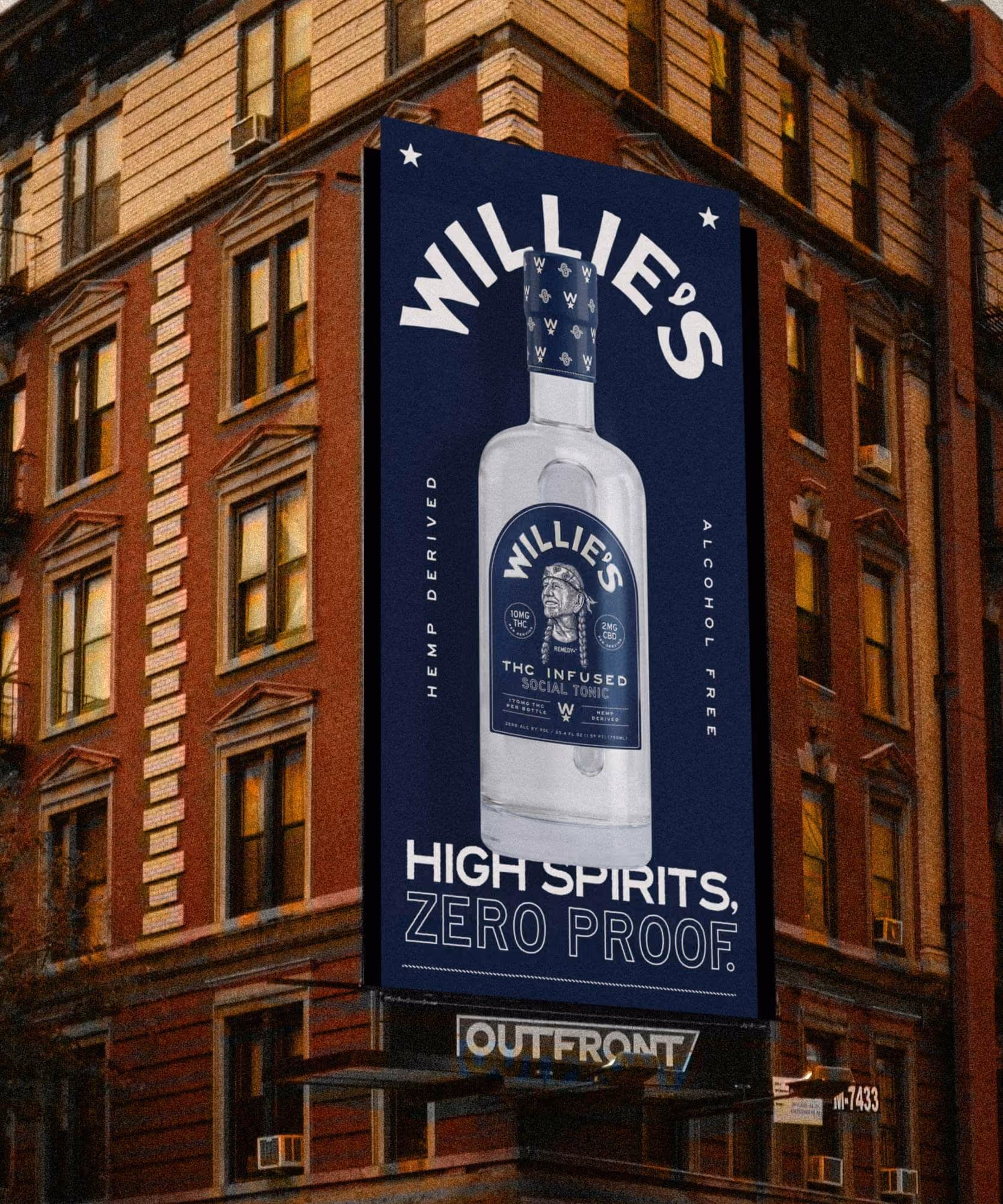 Navy billboard on a brick building reading "High spirits, zero proof." above a Willie's tonic bottle