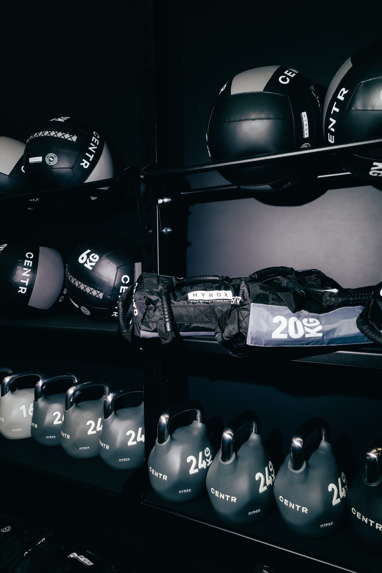 Official HYROX competition equipment at Atlas Training Club — CENTR wall balls, 20kg sandbag and competition kettlebells