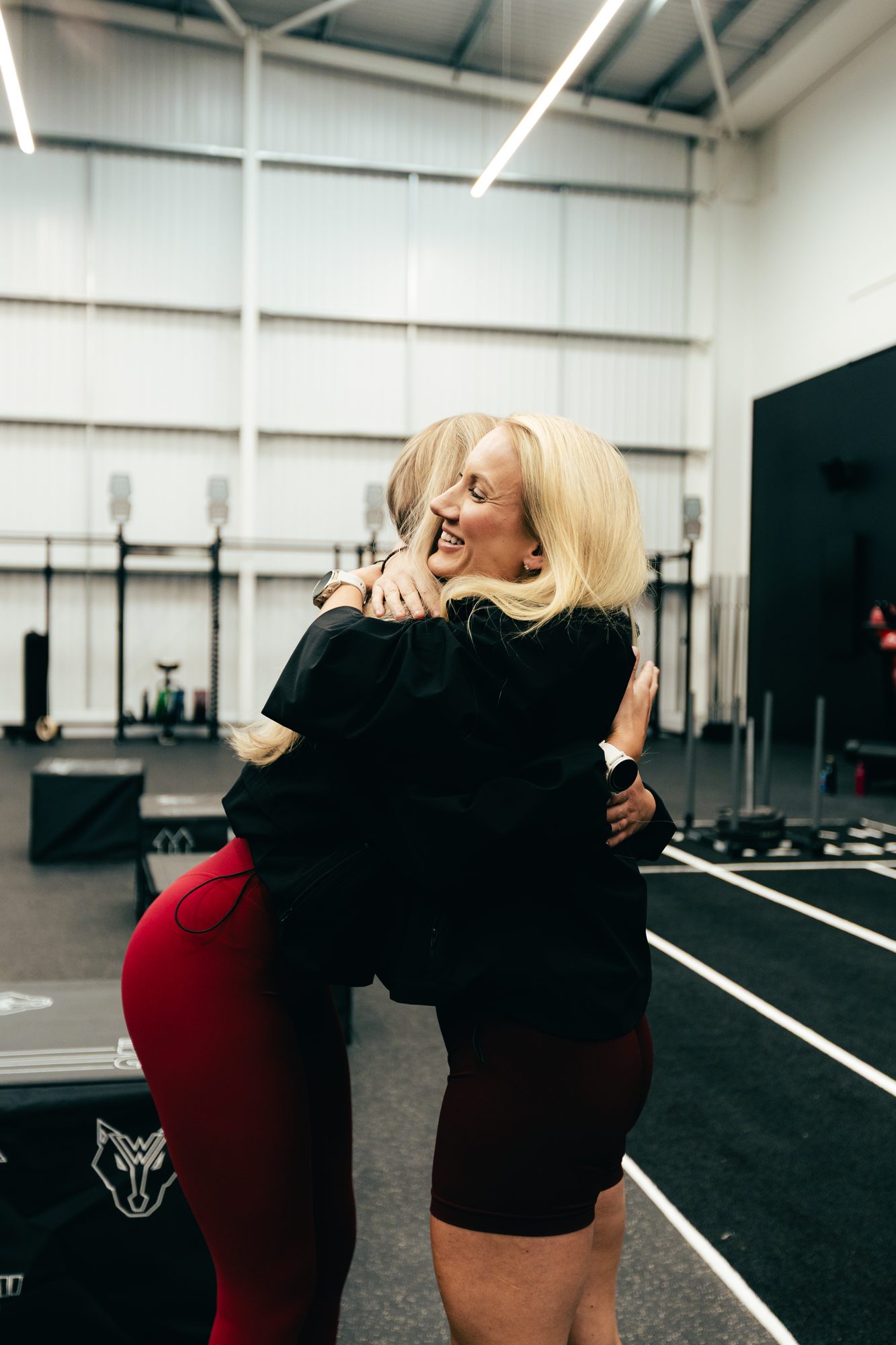 Atlas Training Club members embracing on the gym floor at a club event in Adlington, Cheshire