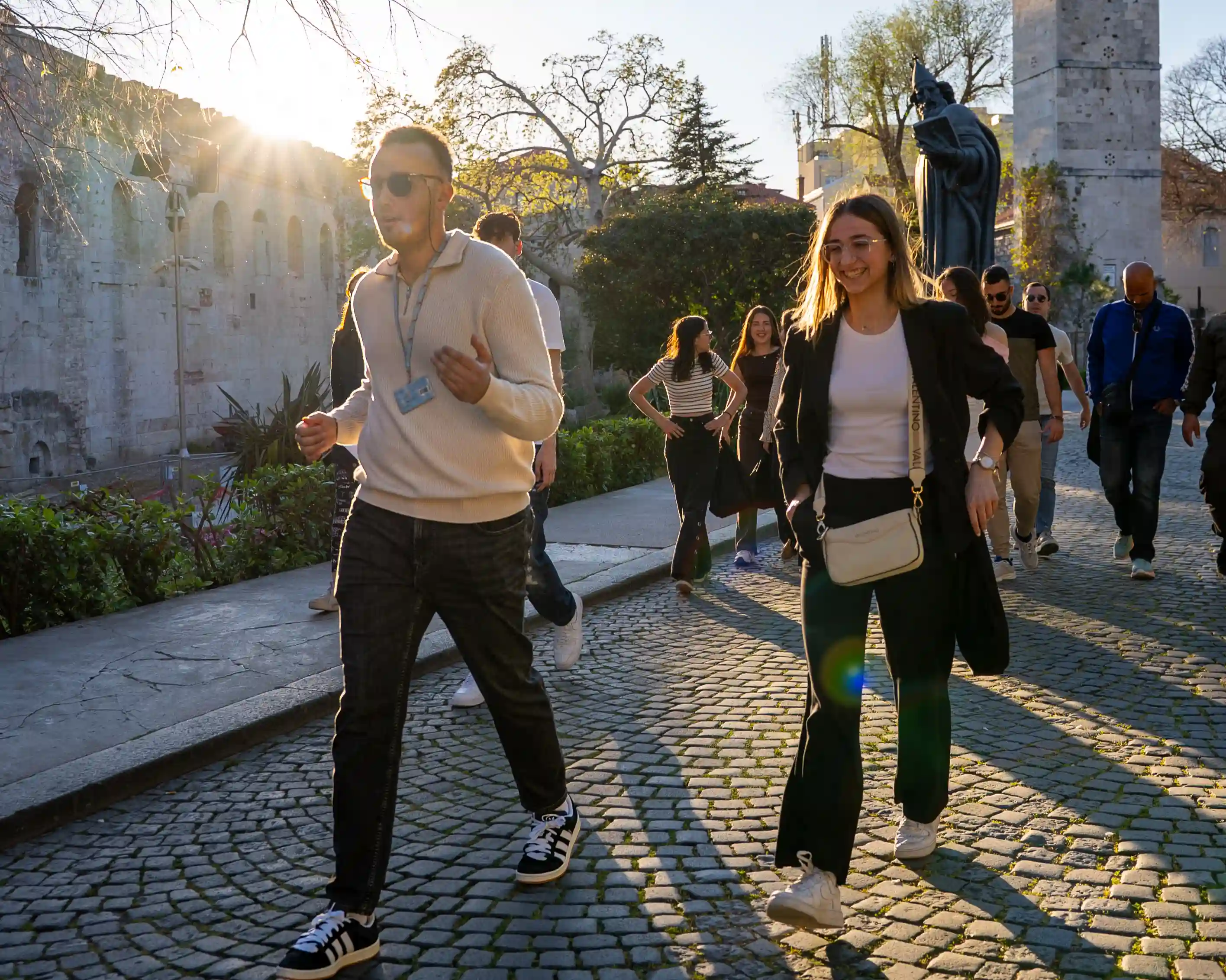 Golden hour Time Walk VR walking tour group at the Golden Gate of Diocletian's Palace, exploring the Old Town streets of Split at sunset with their licensed guide