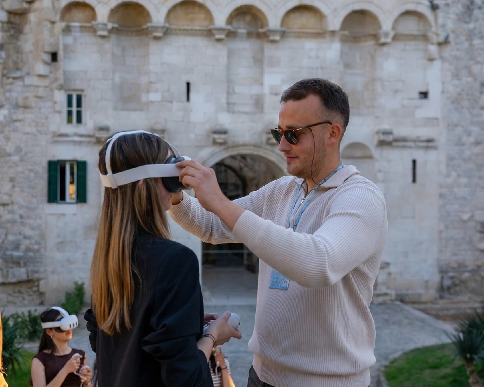 Licensed Time Walk guide helping a guest with a Meta Quest 3 VR headset in Diocletian's Palace, Split