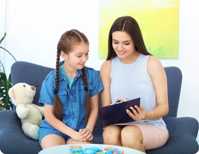 Therapist showing child progress on paper