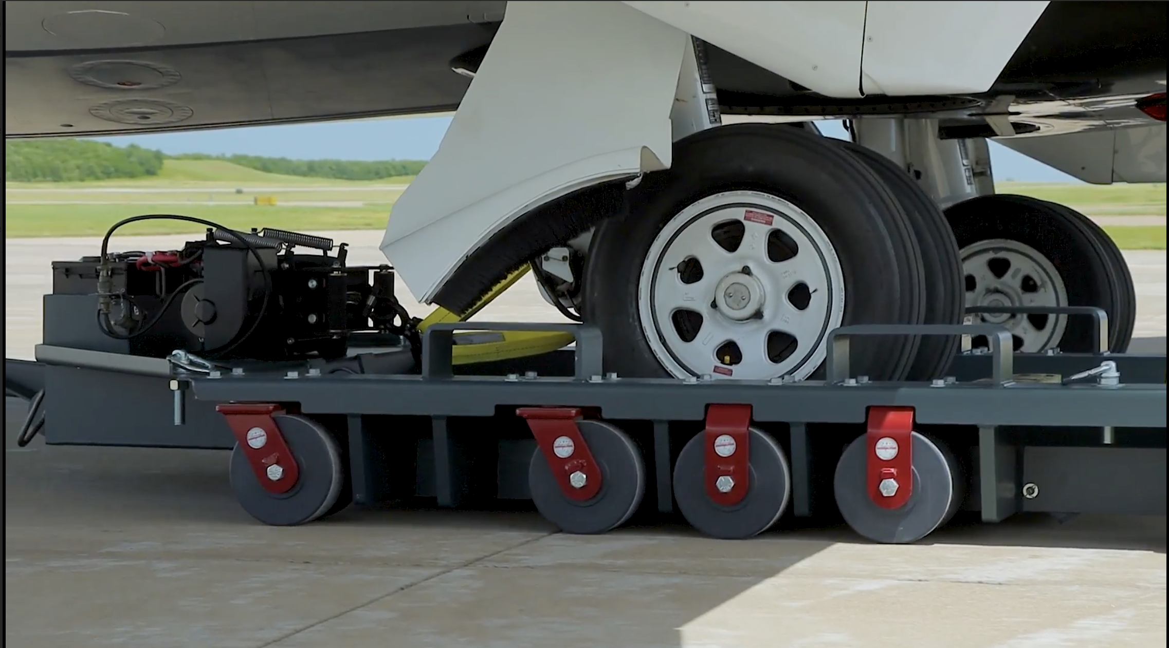 PlaneSkate 100K dolly under aircraft wheel on runway
