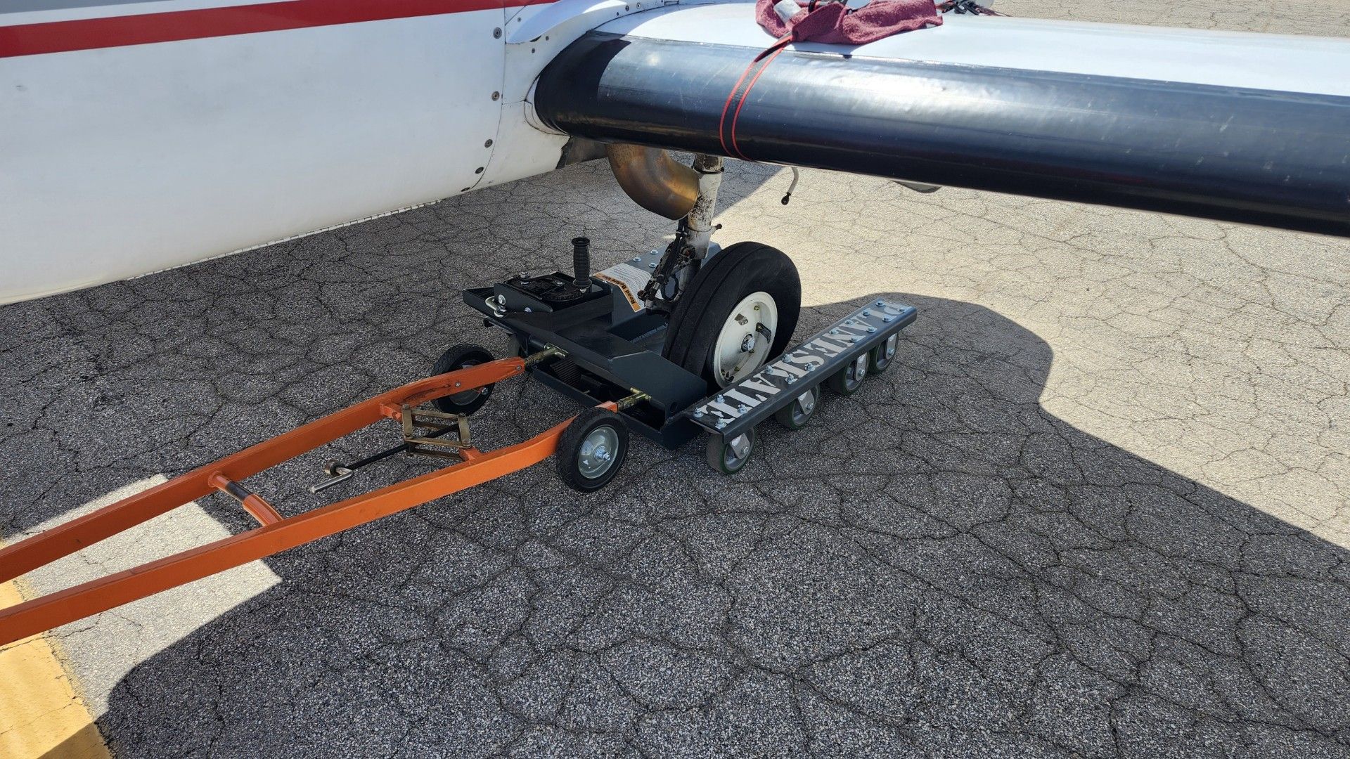 PlaneSkate dolly under aircraft on civilian runway