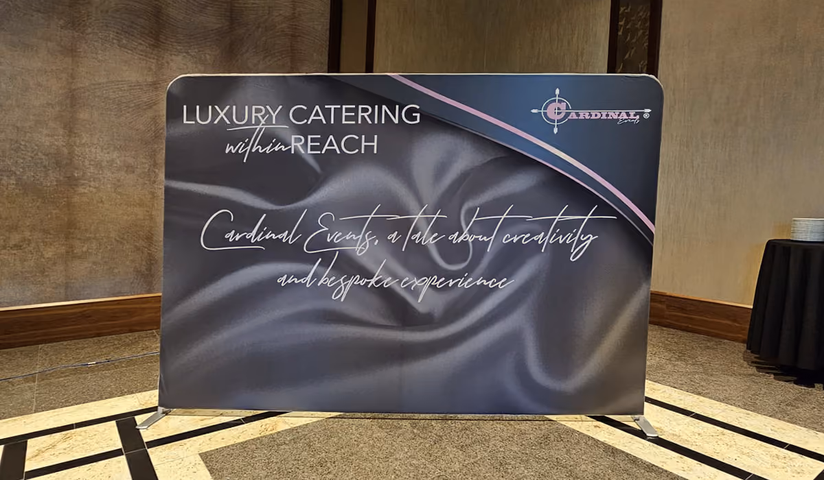 Banner reading Luxury Catering within Reach by Cardinal Events on a silk fabric background.