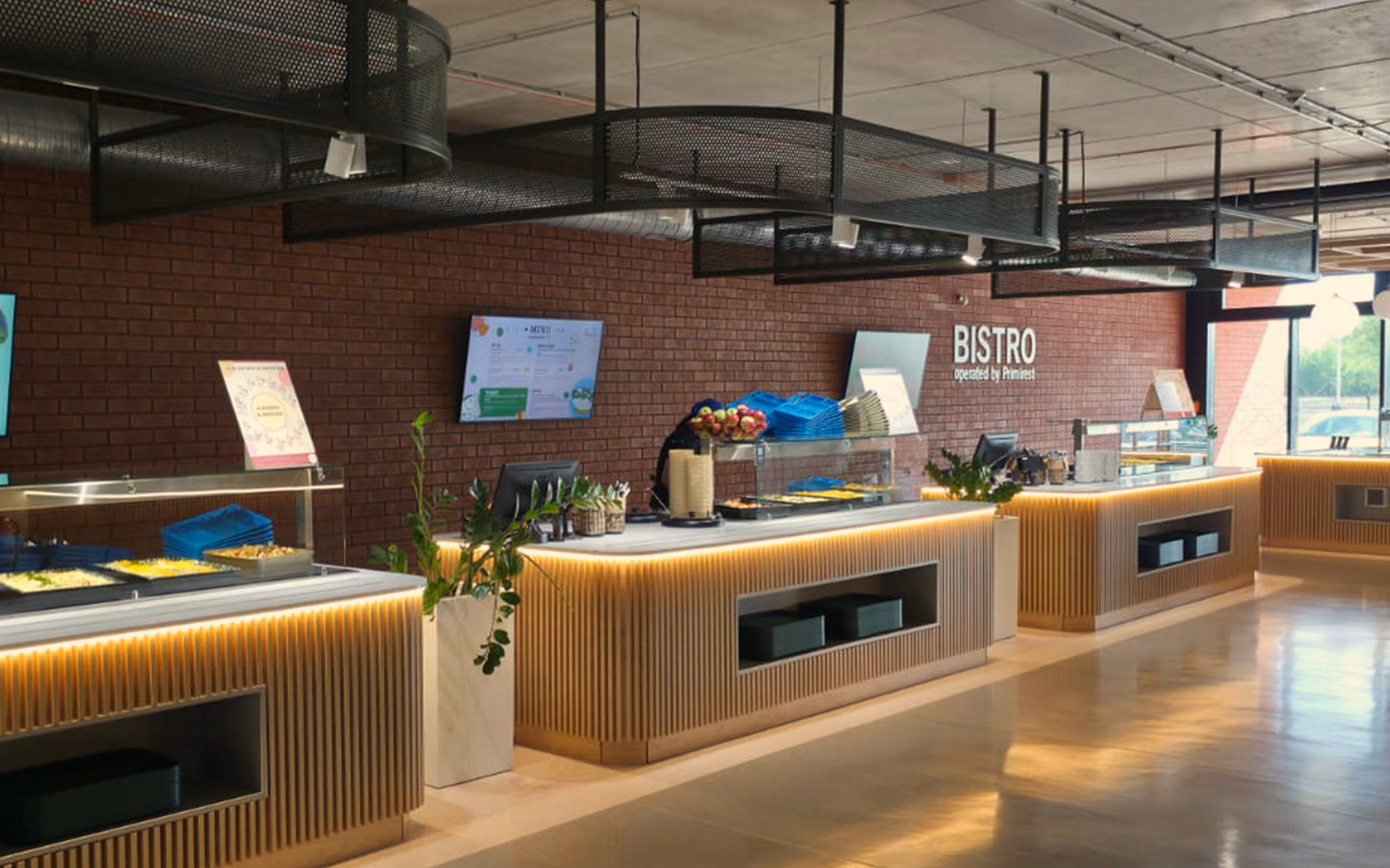 Modern bistro food service counters with digital menus and brick wall interior.