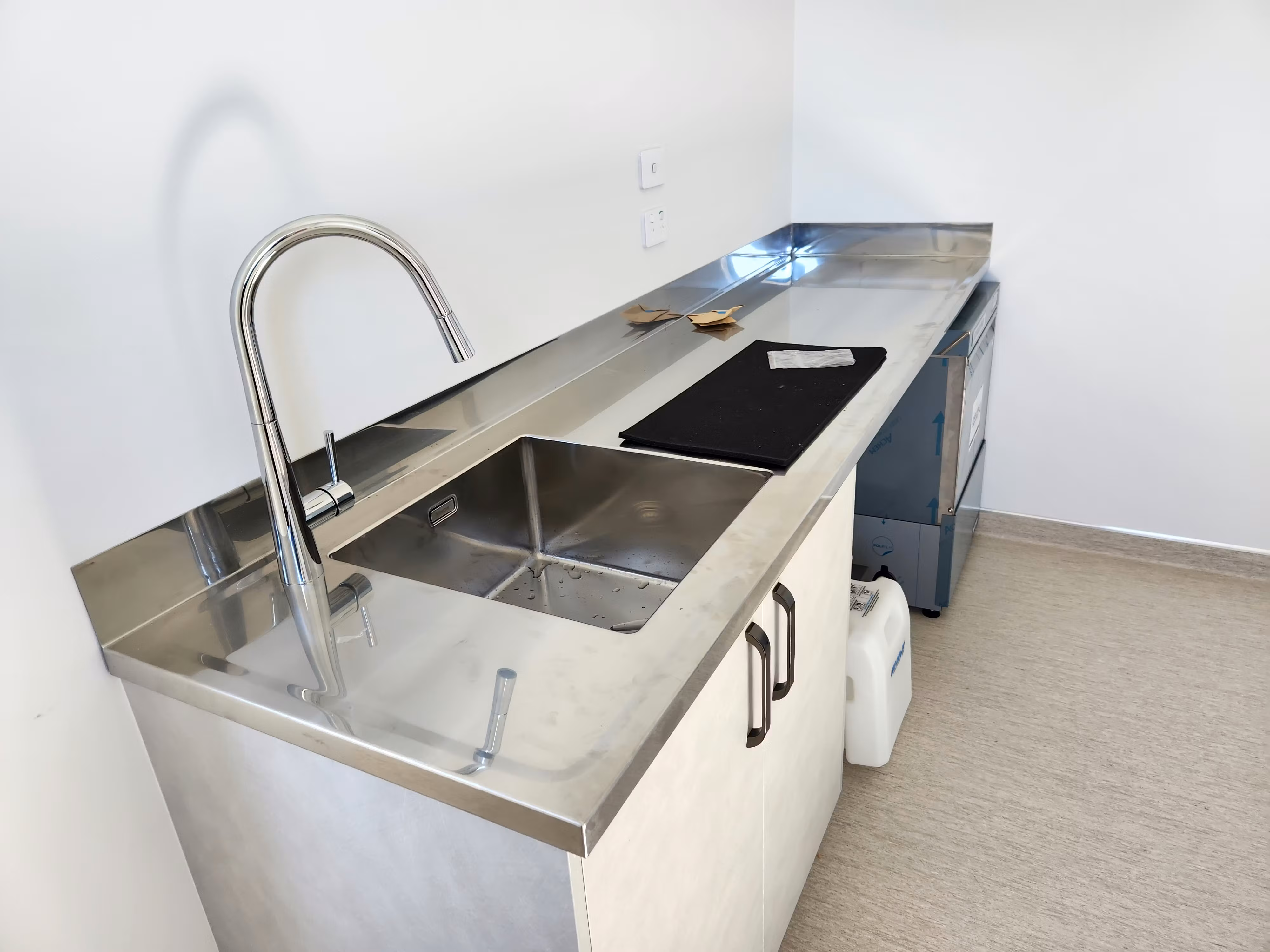 Stainless steel commercial bench and sink install by The Fabricator