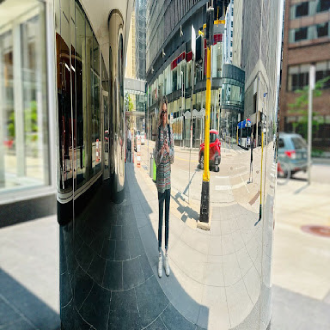 Valerie Hawks reflected in a mirrored downtown Minneapolis building column