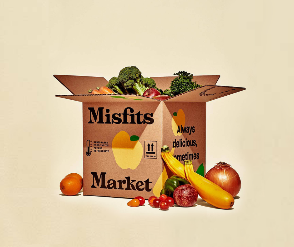 Misfits Market cardboard box packed with produce, with fruit and vegetables around it