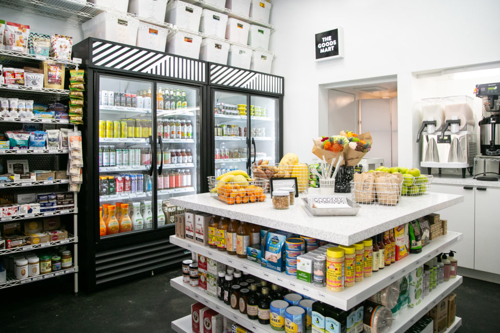 The Goods Mart shop floor with drink coolers and a centre island of produce and pantry goods