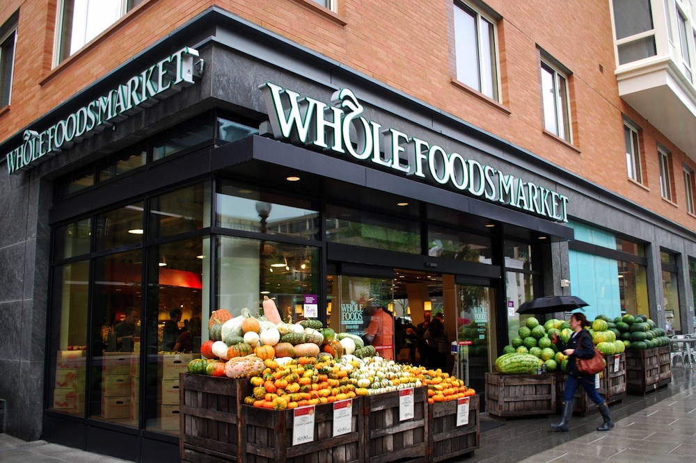 Whole Foods Market storefront with pumpkins and watermelons displayed outside