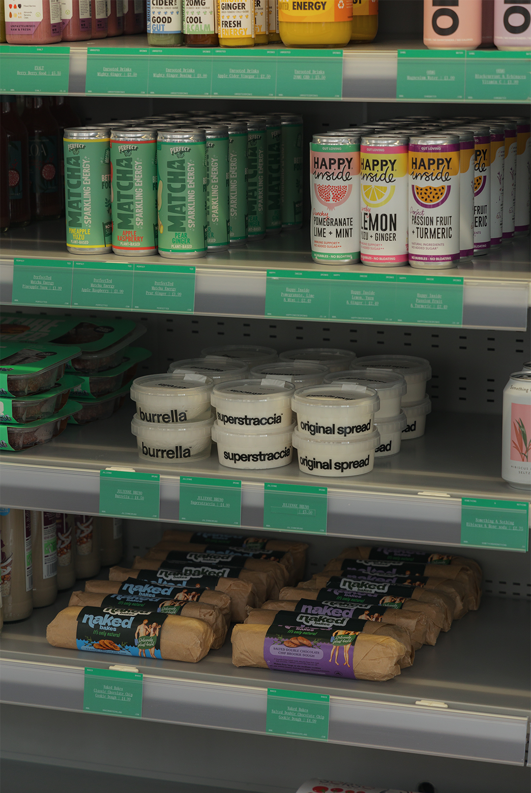 Raye refrigerator shelves stocked with matcha cans, spreads and snacks beside green info cards